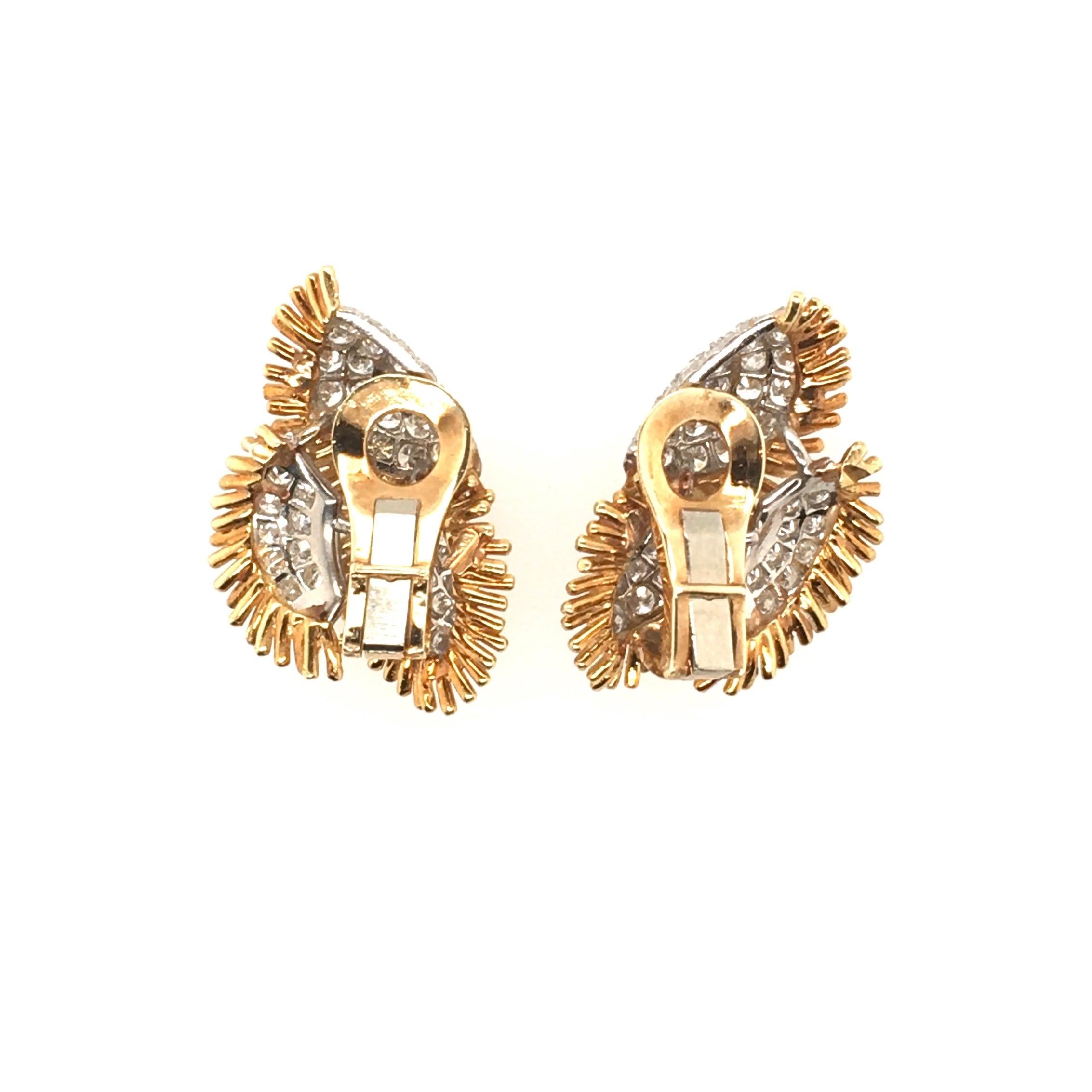 A pair of 18 karat yellow gold, platinum and diamond earrings. Circa 1960. Designed as a cluster of pave set diamond leaves, within gold wire spray surrounds.  Forty four (44) diamonds weigh approximately 2.42 carats. Length is approximately 1 1/4