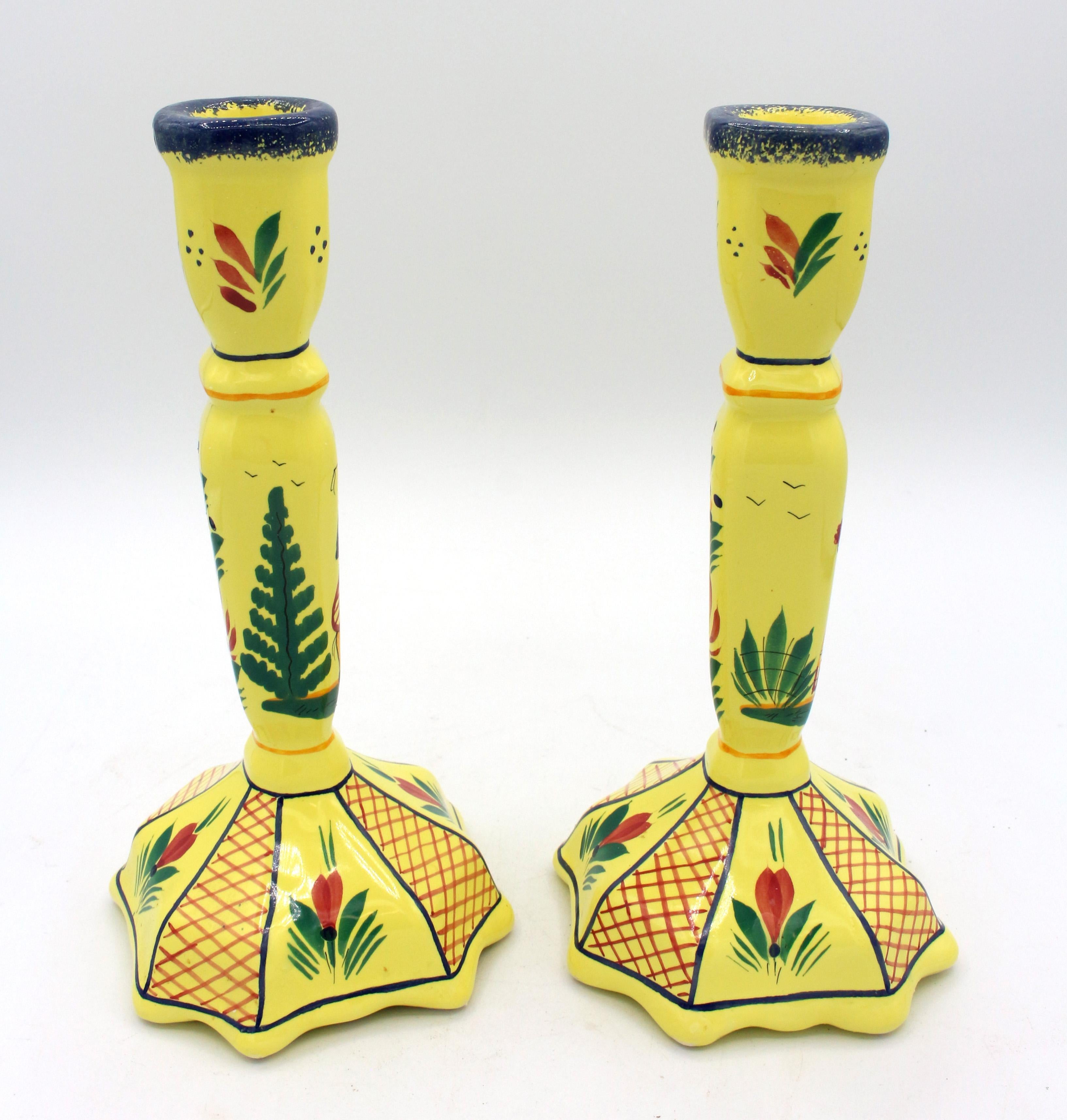 A pair of yellow ground Quimper candlesticks, late 20th century. Henriot Quimper, Grande Maison HB. Man & woman in Breton clothing. 
9