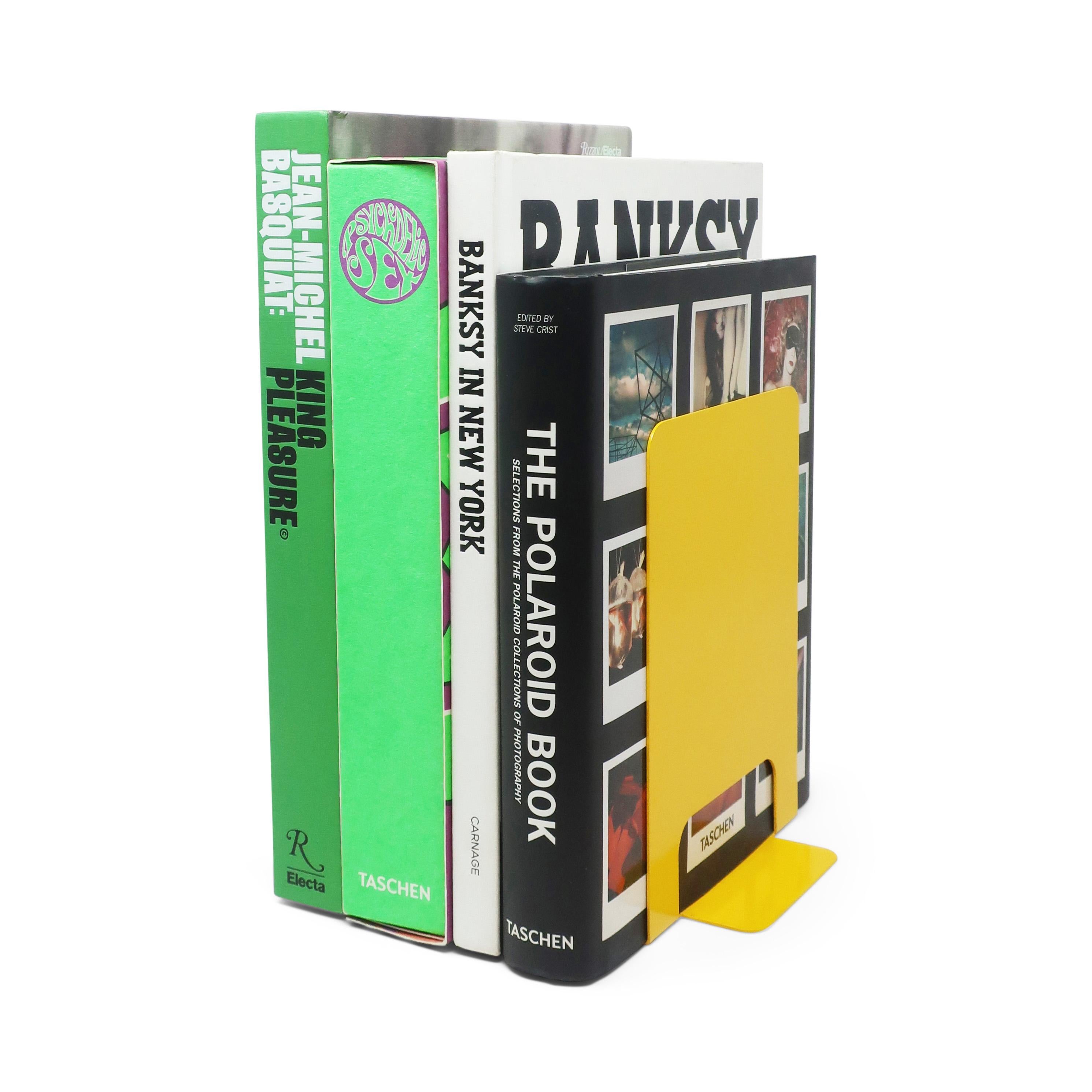 A pair of colorful yellow metal bookends designed by Jorgen Moller for Torben Orskov.  In good vintage condition with normal signs of wear.

6