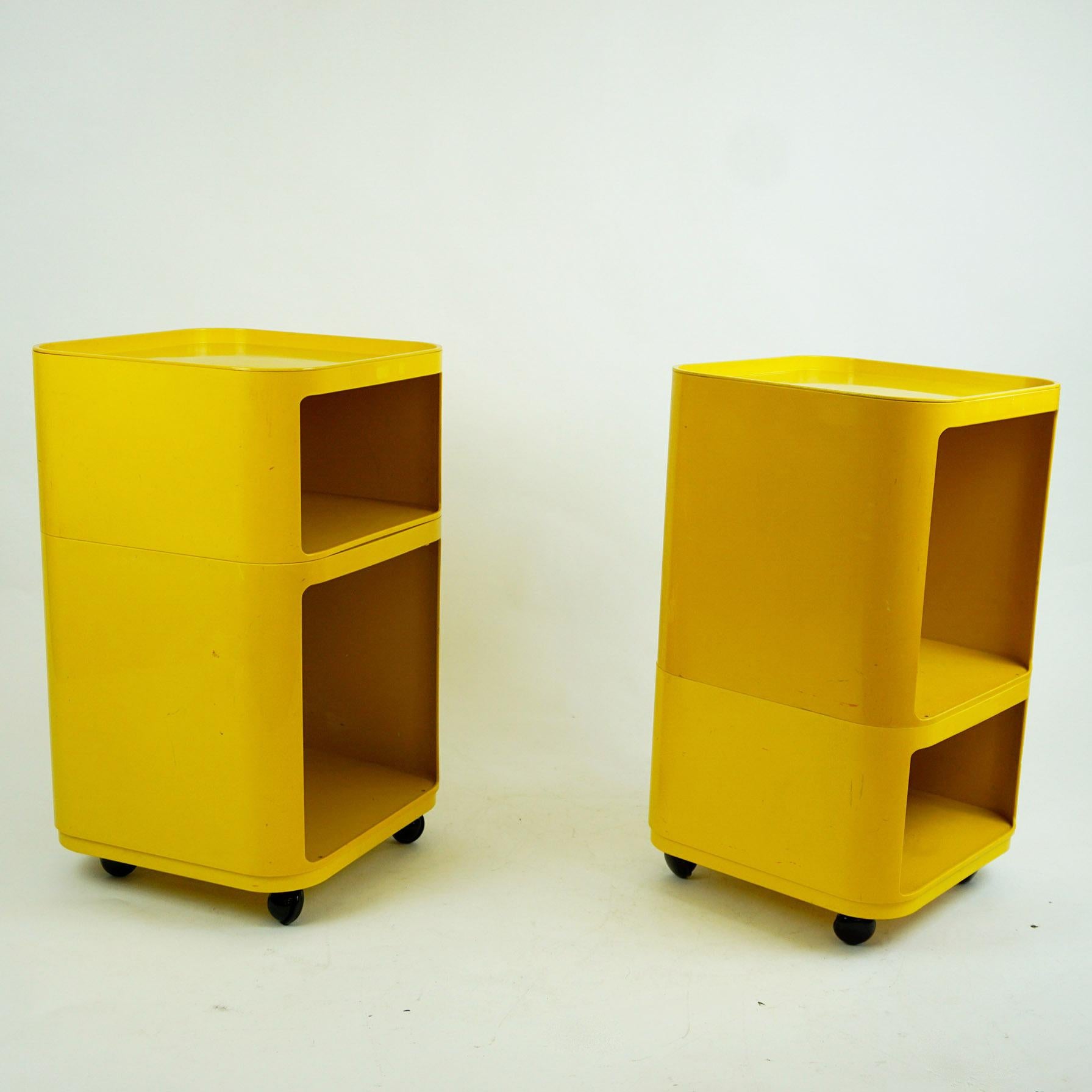 Iconic plastic bar trolleys or bar carts Componibili designed by Anna Castelli for Kartell Italy in the 1970s. They feature four dismountable parts which can be arranged in different ways. Rare in this bright yellow color, the four wheels have been