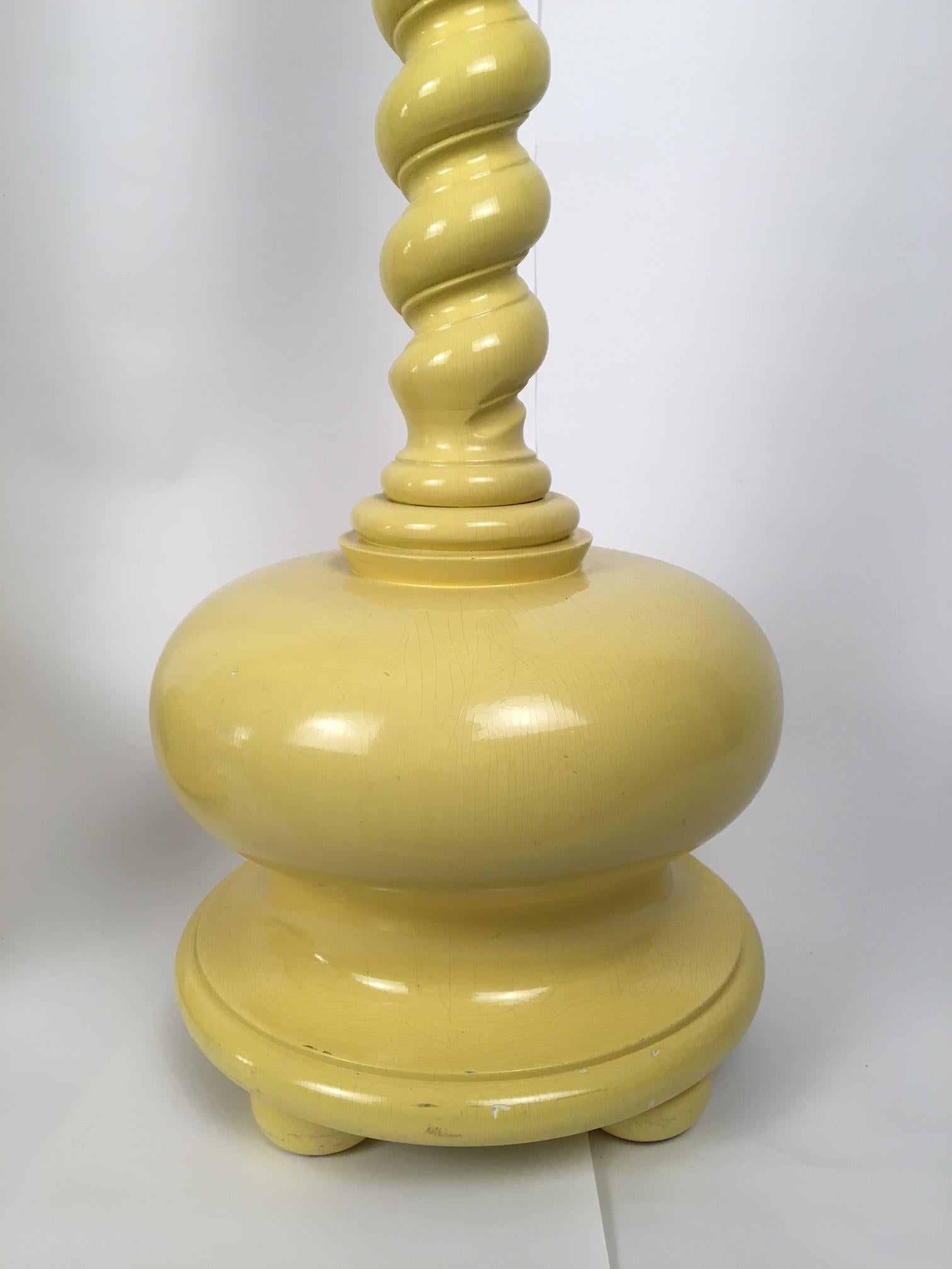 Pair of yellow spiral twist floor lamps with large round bases. Perfect for your Hollywood Regency decor. Each lamp adjusts from 62.5