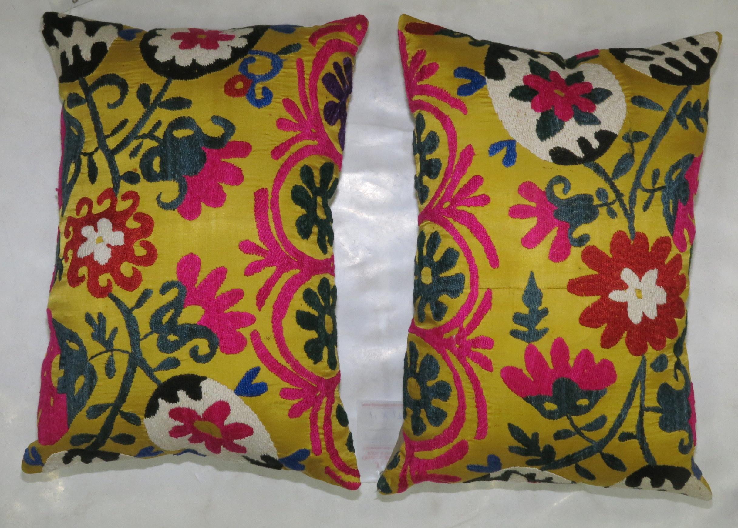 Pair of bright yellow handmade embroidered Suzanni textile pillows each measuring 13'' x 20'.