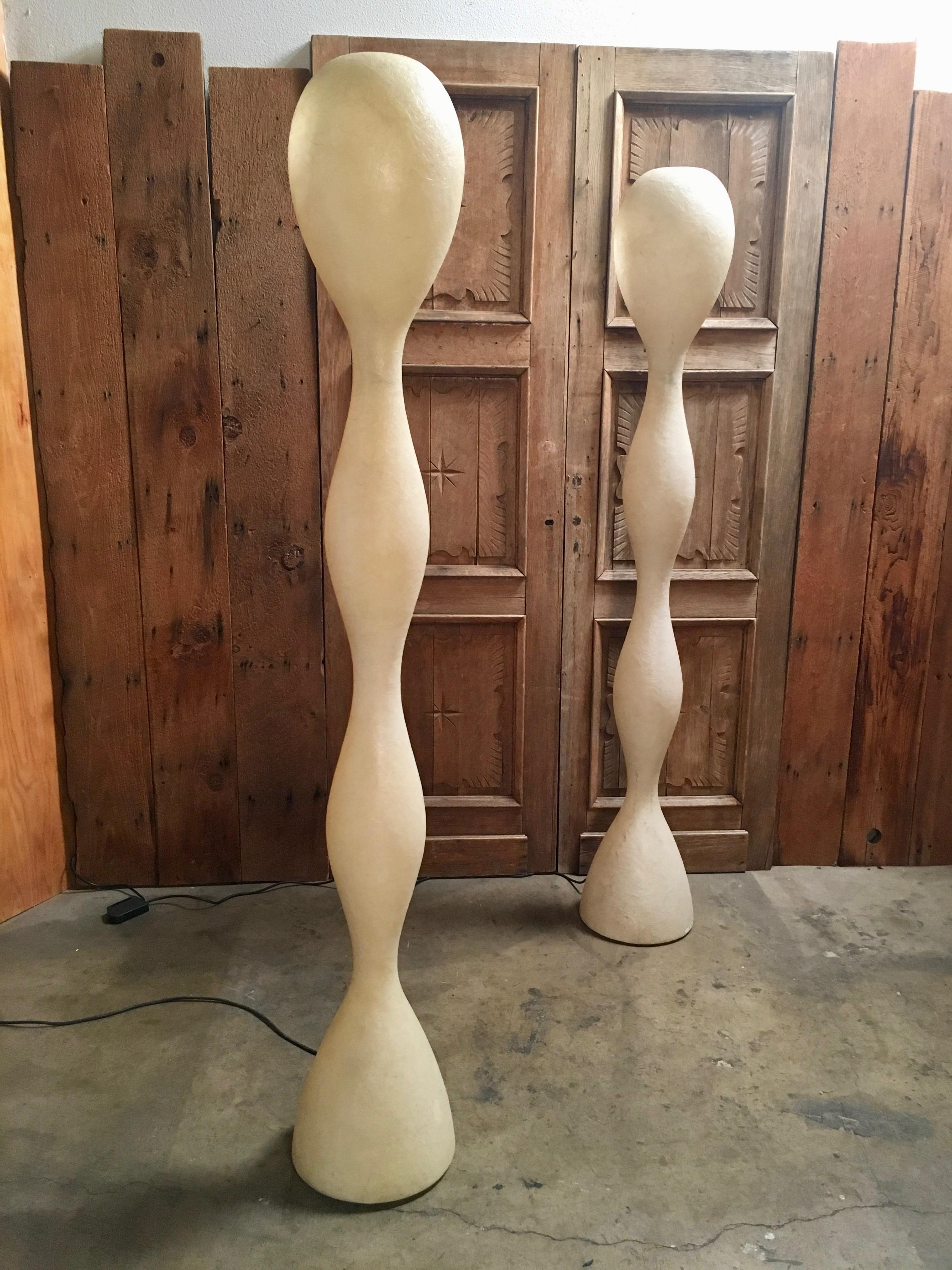 Illuminated off-white sculpted fiberglass floor lamps by Guglielmo Berchicci for Kundalini. With inline dimmer switch.