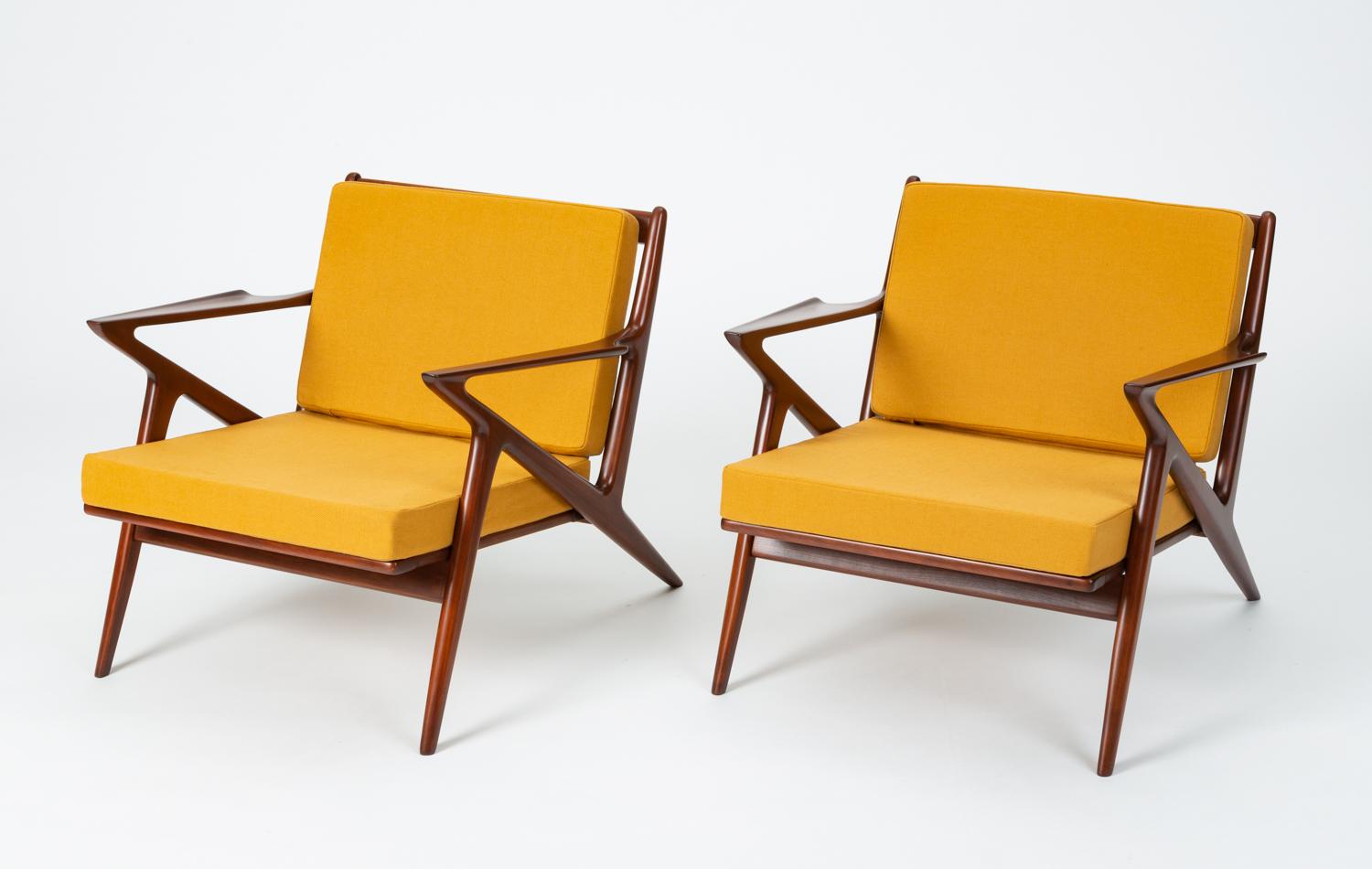 A pair of Danish modern classics from Poul Jensen and Selig. An enduringly popular design, the Z chair derives its name from the sharp angles and pointed armrests of the frame. This pair has been fully restored, with a refinished frame in the