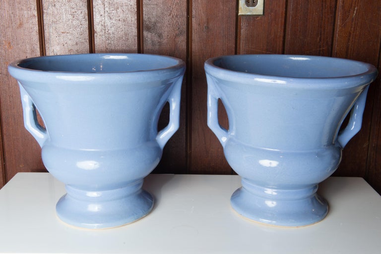 A pair of urns in a rich periwinkle blue from Ohio based Zanesville Pottery. Color in photos is accurate.