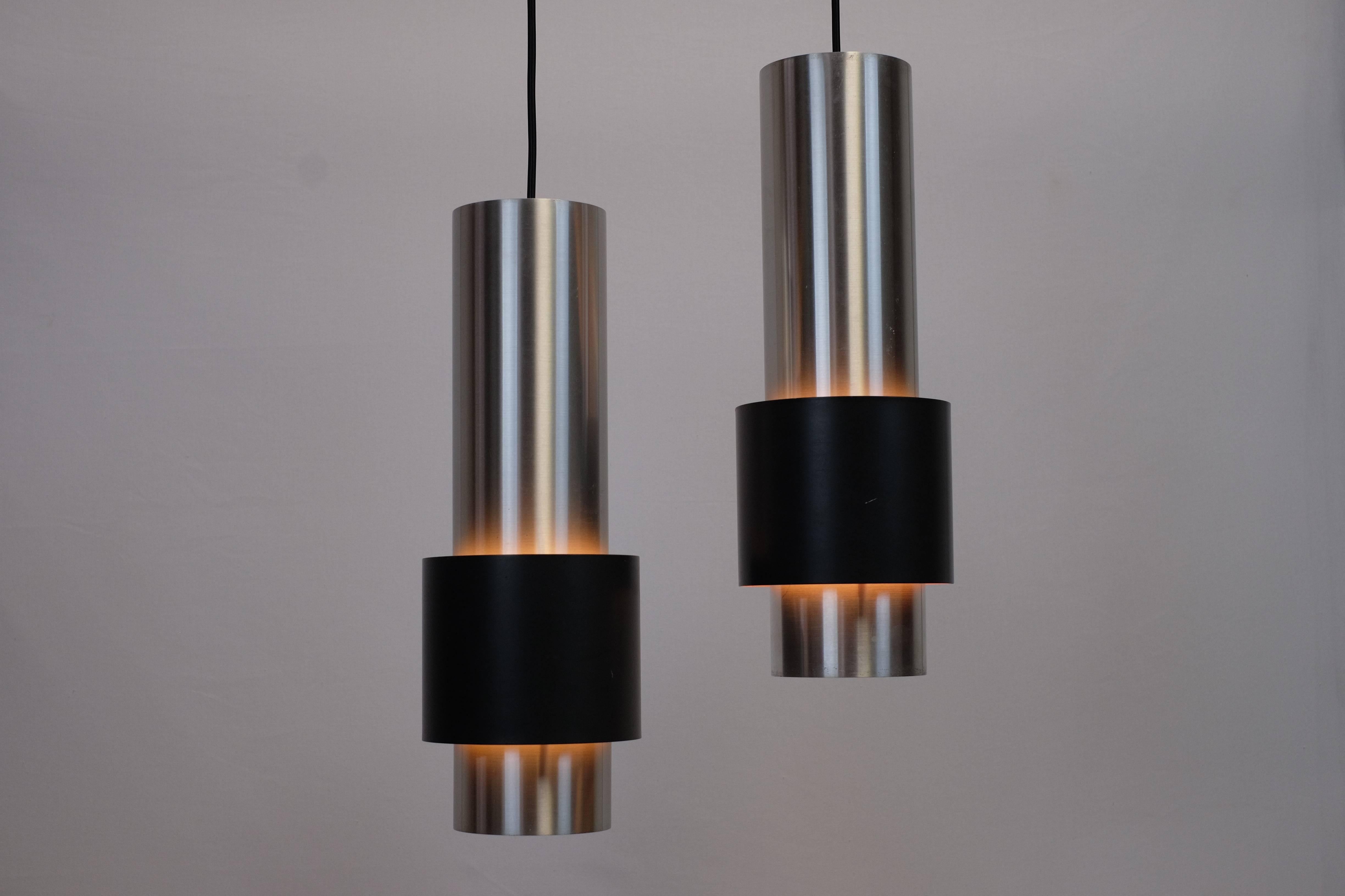 These stunning pendant lamps, model Zenith, was designed by Jo Hammerborg and produced by the Danish manufacturer Fog & Mørup in 1967. The lamps is made from aluminium with the outer cylinder painted in a matte anthracite color. The inside of this