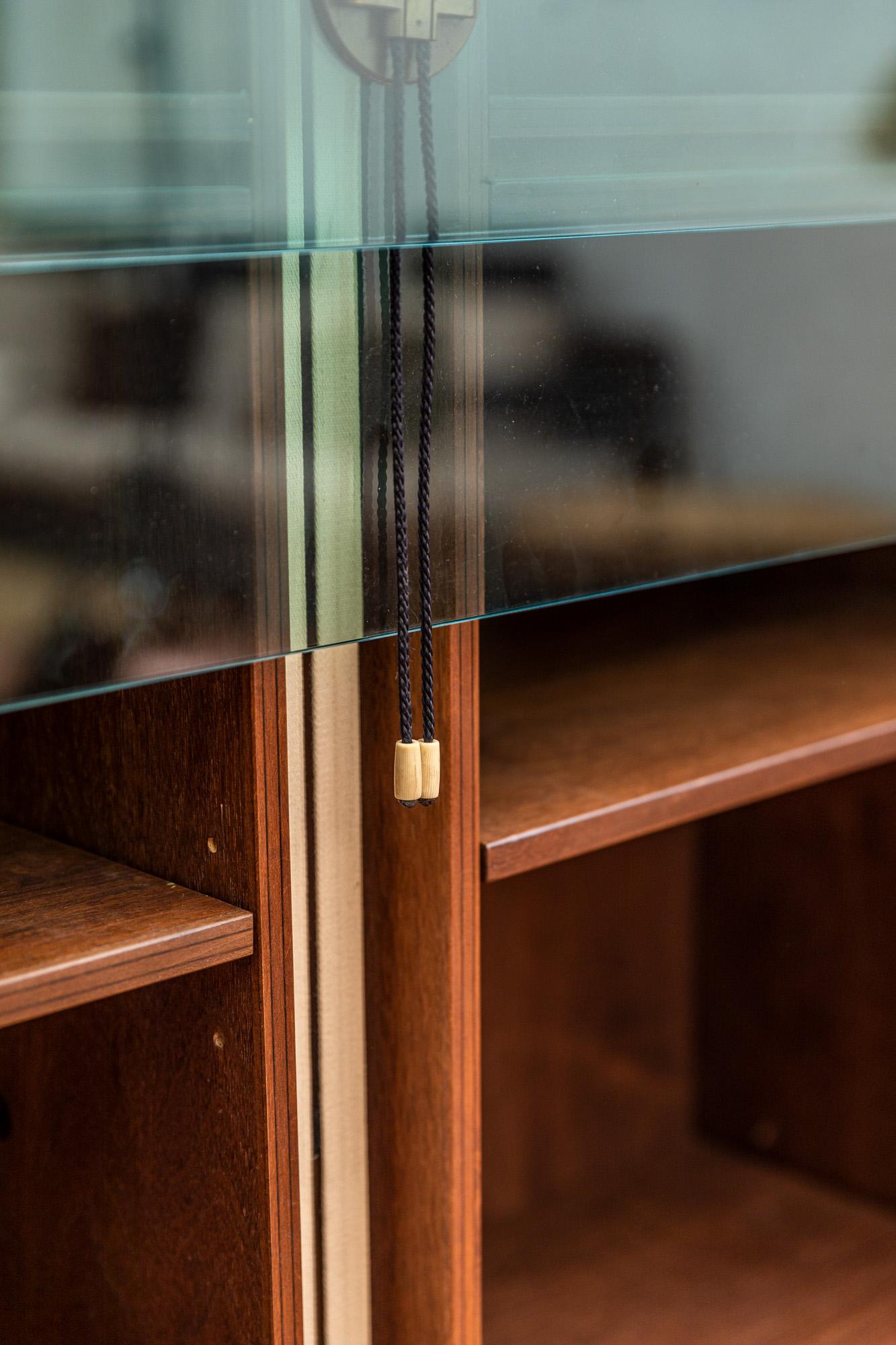 Iconic bookcases designed by Carlo Scarpa for Bernini in 1974.
Signed Bernini in brass details.
The bookcases have 3 compartments: two accessible thanks to the sliding glass by means of a counterweight, the other hinged on the bottom. 
Original