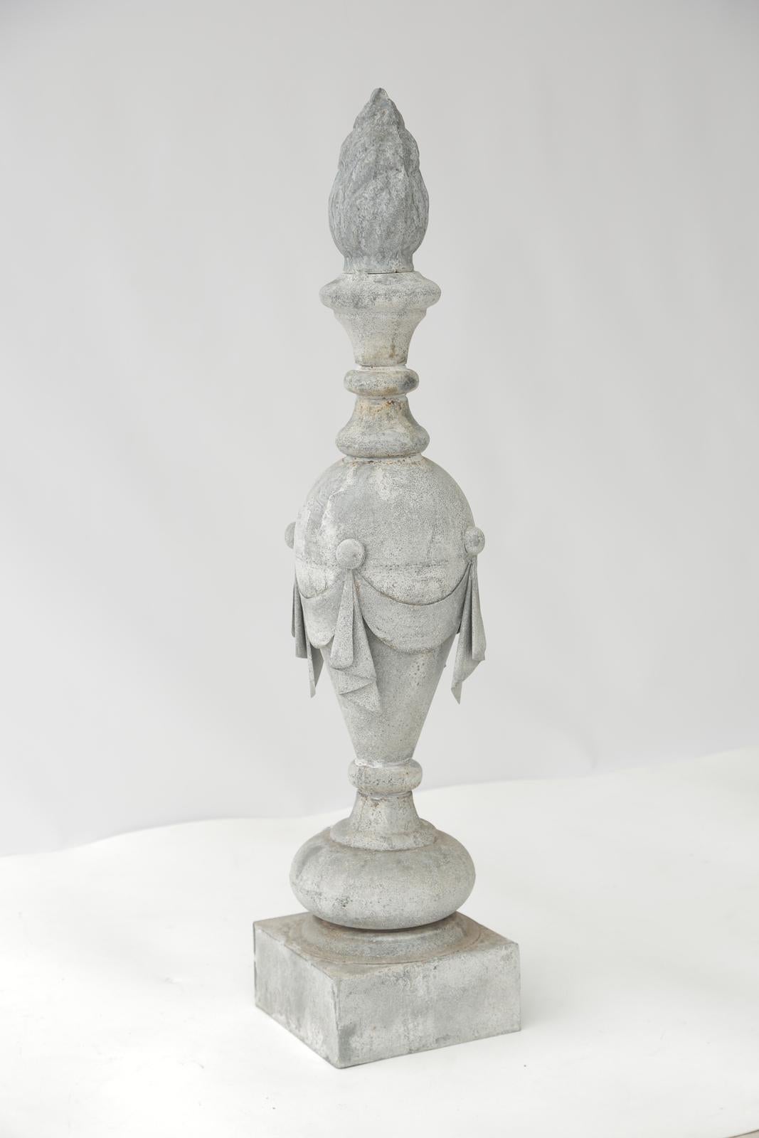 Pair of zinc decorative building finials, each fashioned as a draped flaming urn, in baluster-form, on square plinth. 

Stock ID: D8647.