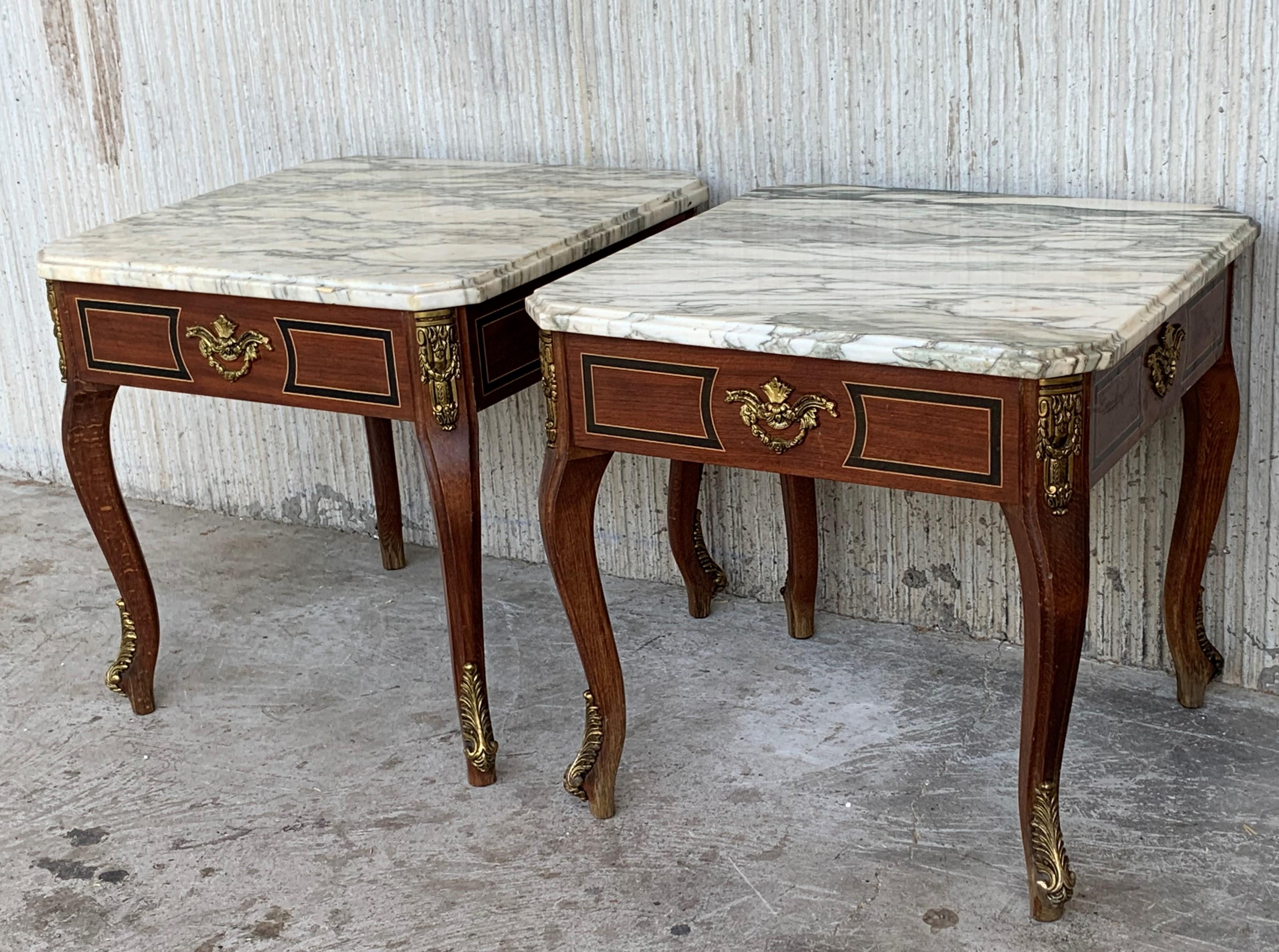 This Louis XV style square tables with marble tops are made of walnut, with four tapered legs each table. The pieces has exquisite detailed bronze mounts and marble top.

Pair of square tables: 19.68in x 19.68in, height 18.89in.