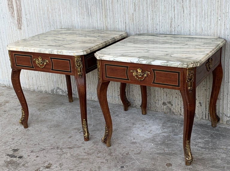 This Louis XV style square tables with marble tops are made of walnut, with four tapered legs each table. The pieces has exquisite detailed bronze mounts and marble top.

Pair of square tables: 19.68in x 19.68in, height 18.89in.