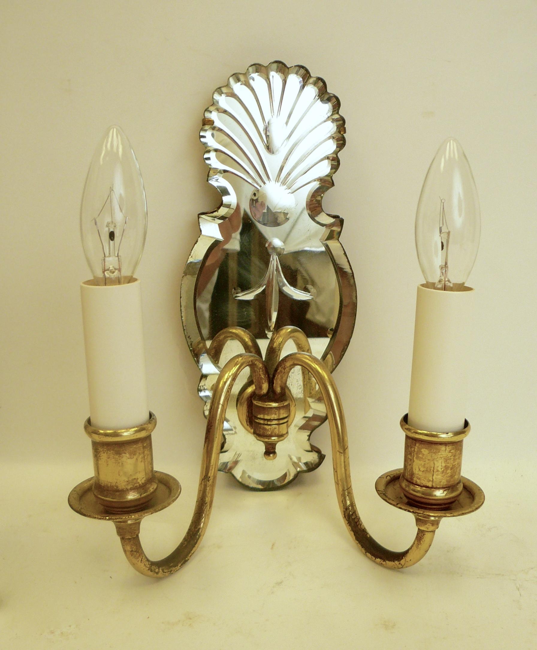 These quality sconces with wheel cut mirrored backs feature shell motifs, and bevelled borders.