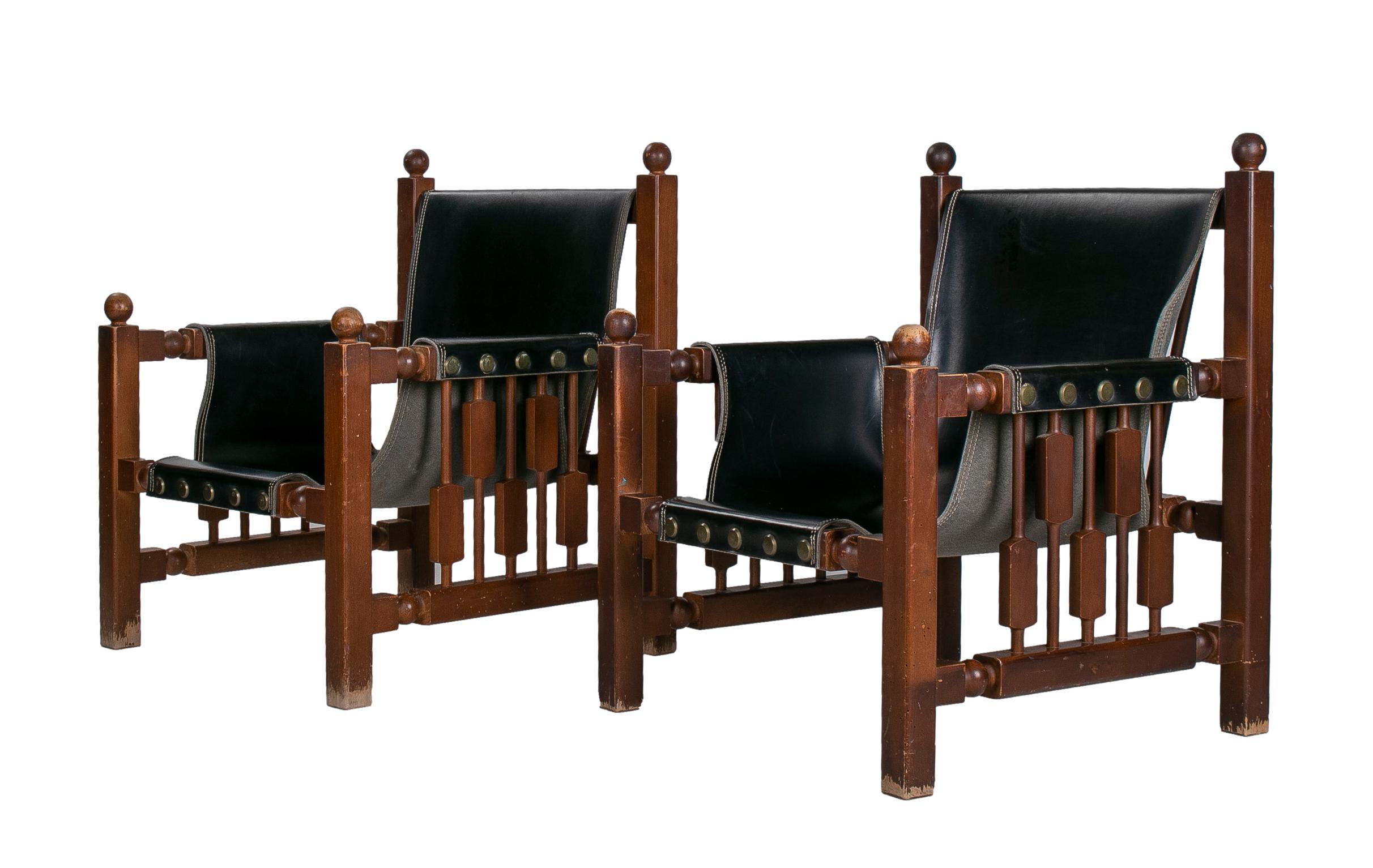 Pair of 1960s Spanish Paco Muñoz designer wood and leather armchairs.
