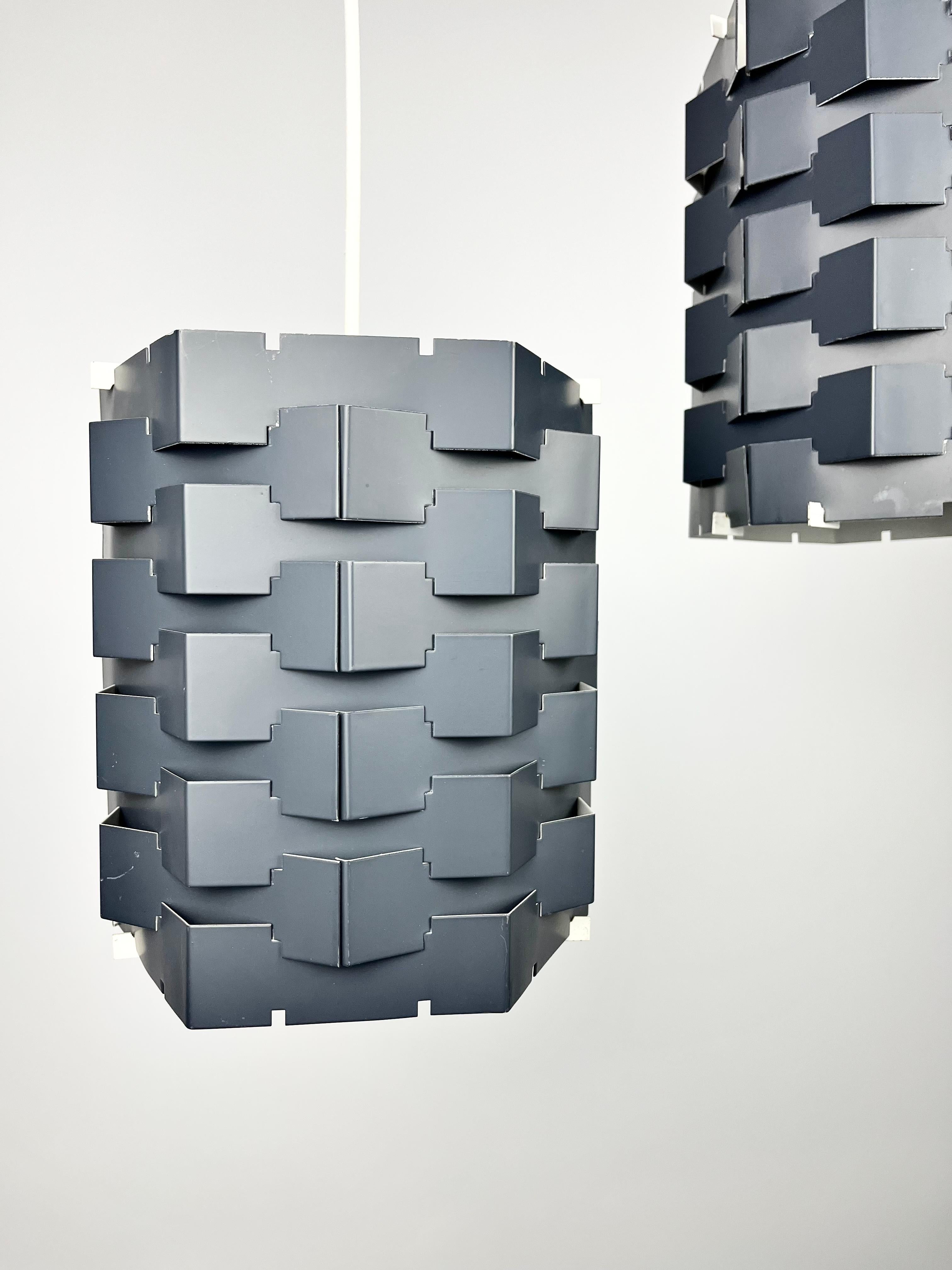 This awesome pair of original mid century light shades have a particularly architectural look to them!
Dating from the 1960s, they’re constructed from sheet metal which has been cut into interlocking sections and slotted together to create this