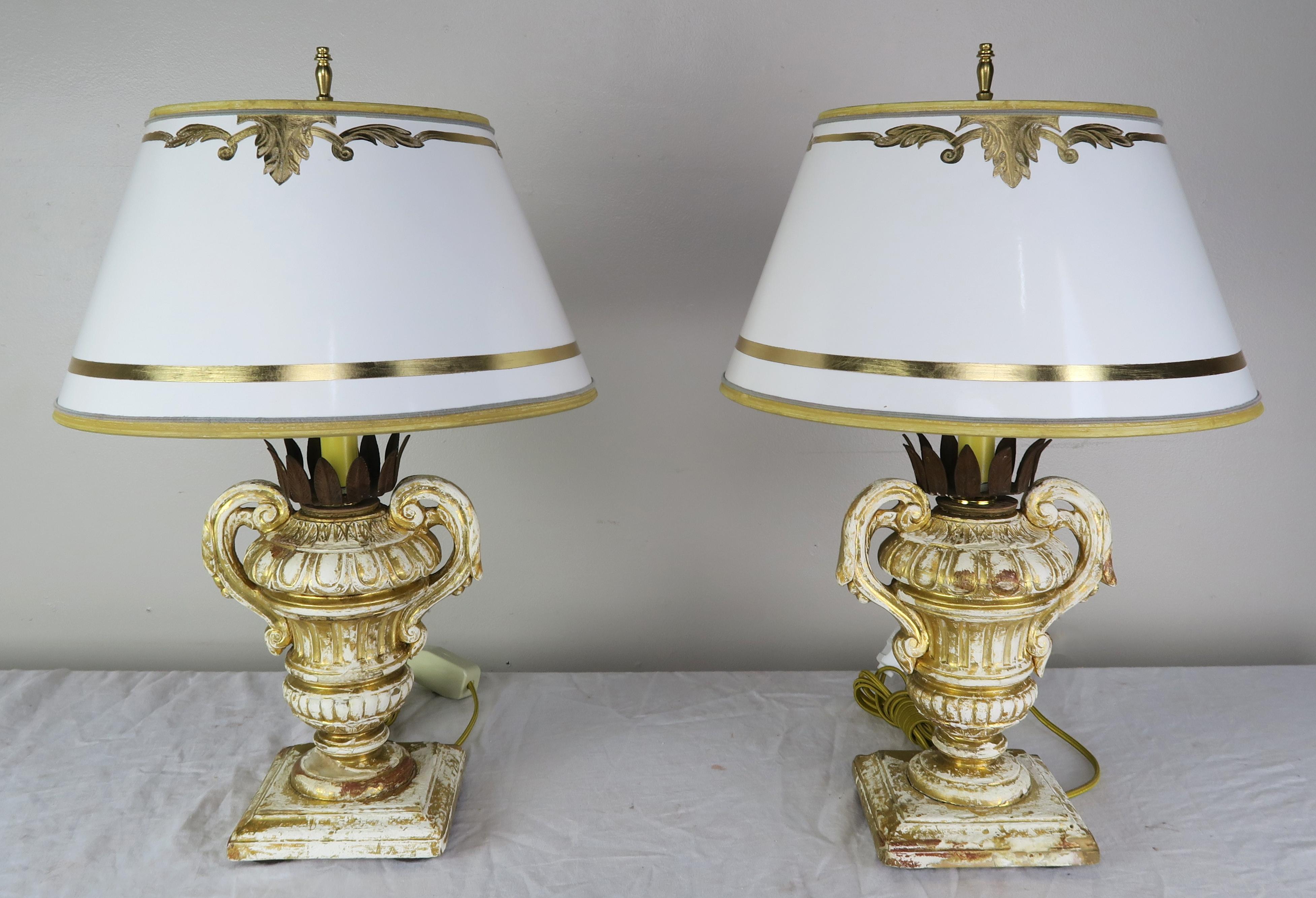 Pair of candleholders from the early 1900s. The handled urns have metal crown shaped bobeches that hold a candle that has been newly electrified into lamps. The lamps are crowned with hand painted parchment shades that coordinate perfectly with the