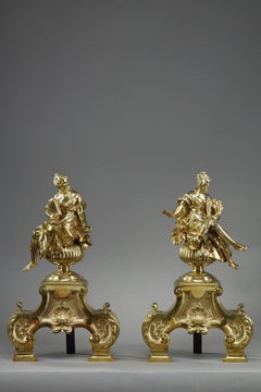 Pair or Louis XIV style andirons decorated with seated Muses