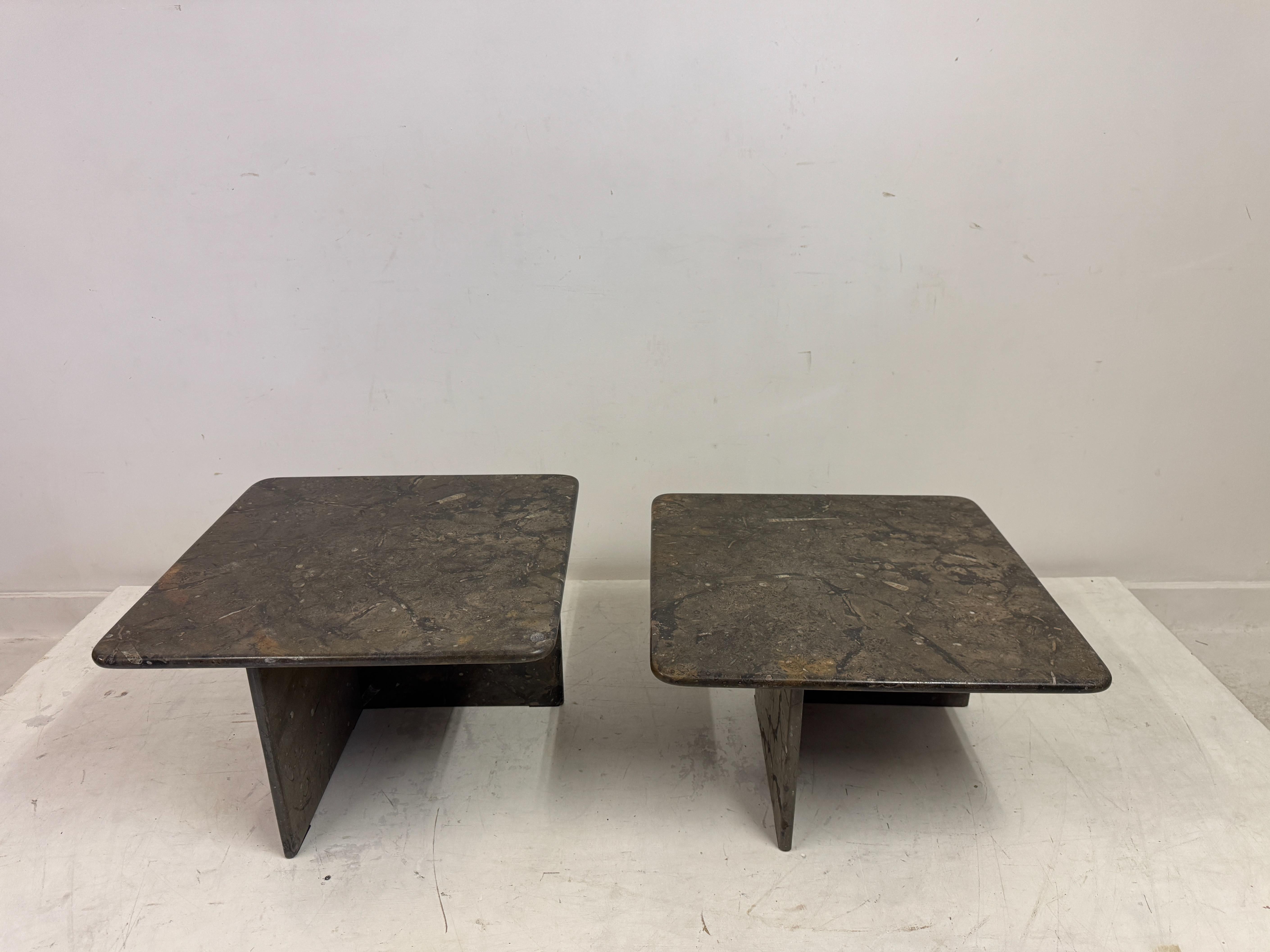 Nest of two fossil stone coffee or side tables.

A striking nest of fossil stone coffee tables, featuring a sculptural, monolithic design that seamlessly blends organic texture with a Brutalist aesthetic. The duo consists of two interlocking forms,