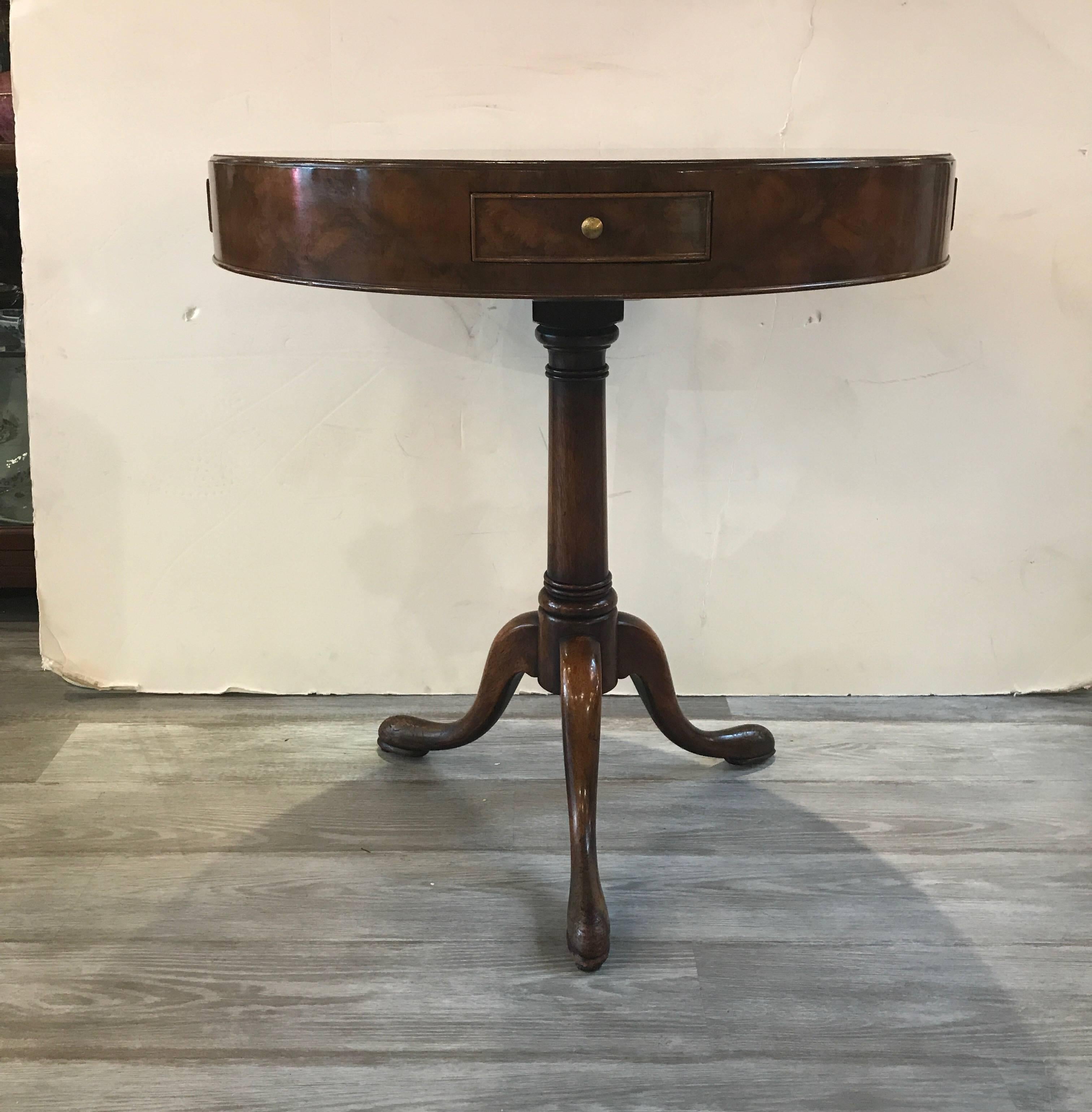 Beautiful and simplistic round side tables with pedestal base. The highly figurative tops with thick apron with four small drawers all around. Well cared for with a recent French polish.