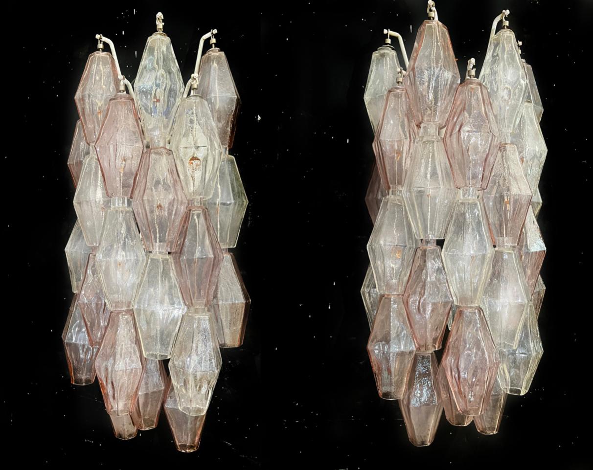 Pair of unobtainable wall sconces made by Carlo Scarpa for Venini. They are composed of rows of transparent and slightly pink colored glass. The frames shows signs of time but the glass is perfect.