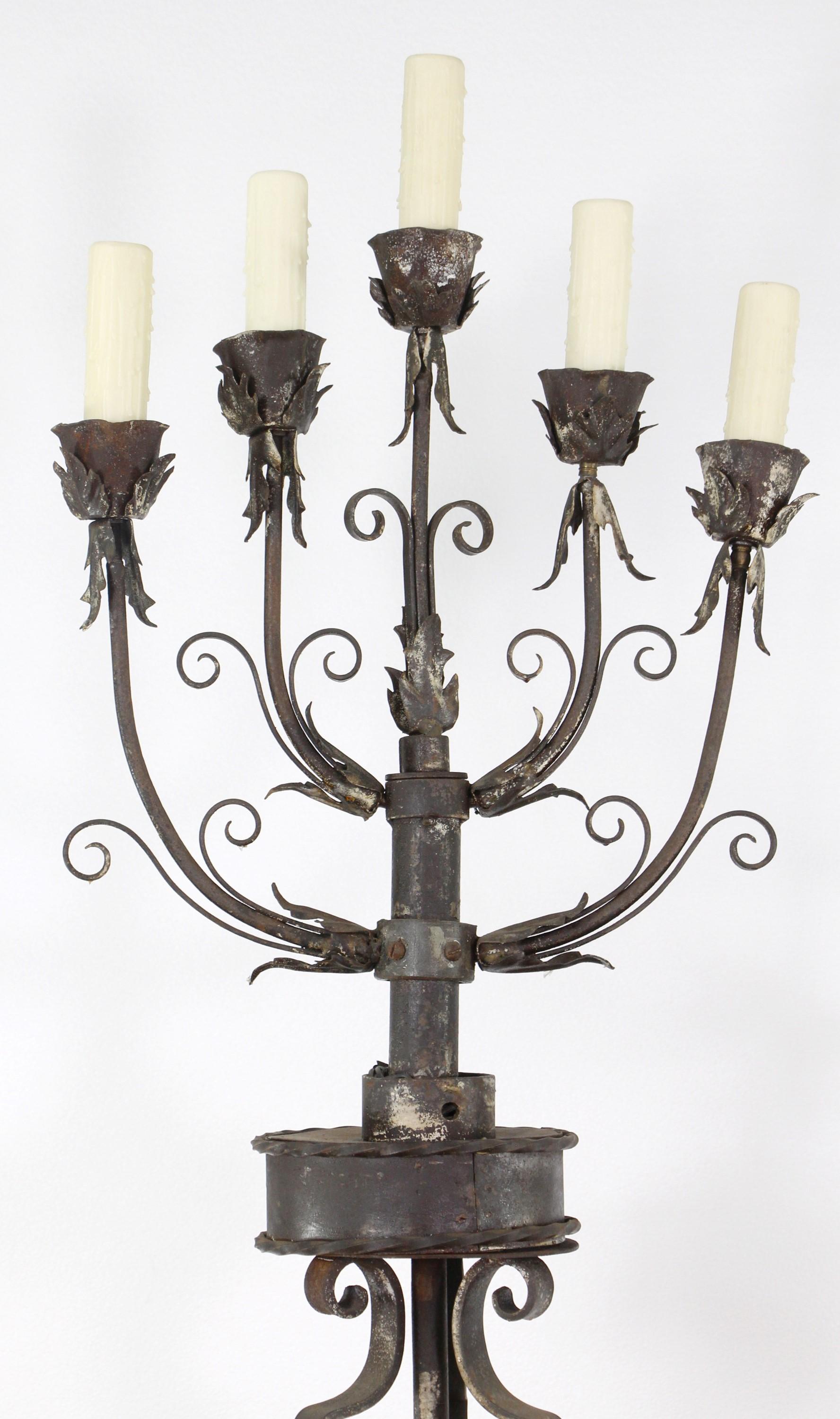 Over the top 19th Century pair of candelabra floor lamps. Hand wrought iron with Floral and leaf details. Handmade with bands and pinned together. Now restored and electrified. Each floor lamp has 5 sockets. Priced as a pair. This can be seen at our