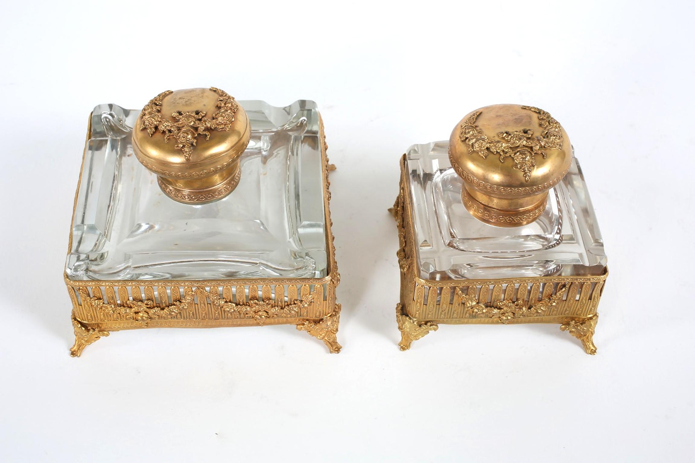 Pair of ornately gilt brass footed framed with cut glass holder inkwells. Each one is in great vintage condition with wear appropriate to age / use . Large one is 3. 3