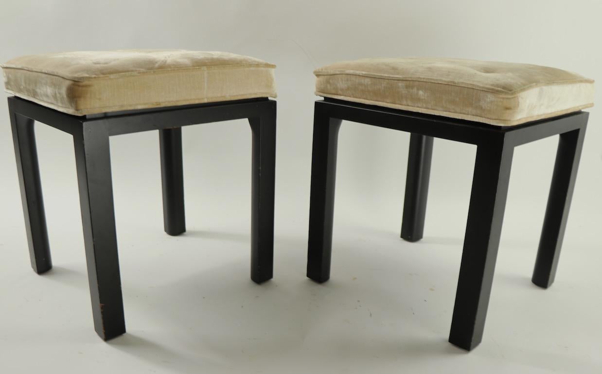 Chic and stylish pair of stools designed by Harvey Probber. Both are in good original condition, the upholstered tops show cosmetic wear, usable as is or we can provide custom reupholstery if you would like a more polished look. Black finish on wood