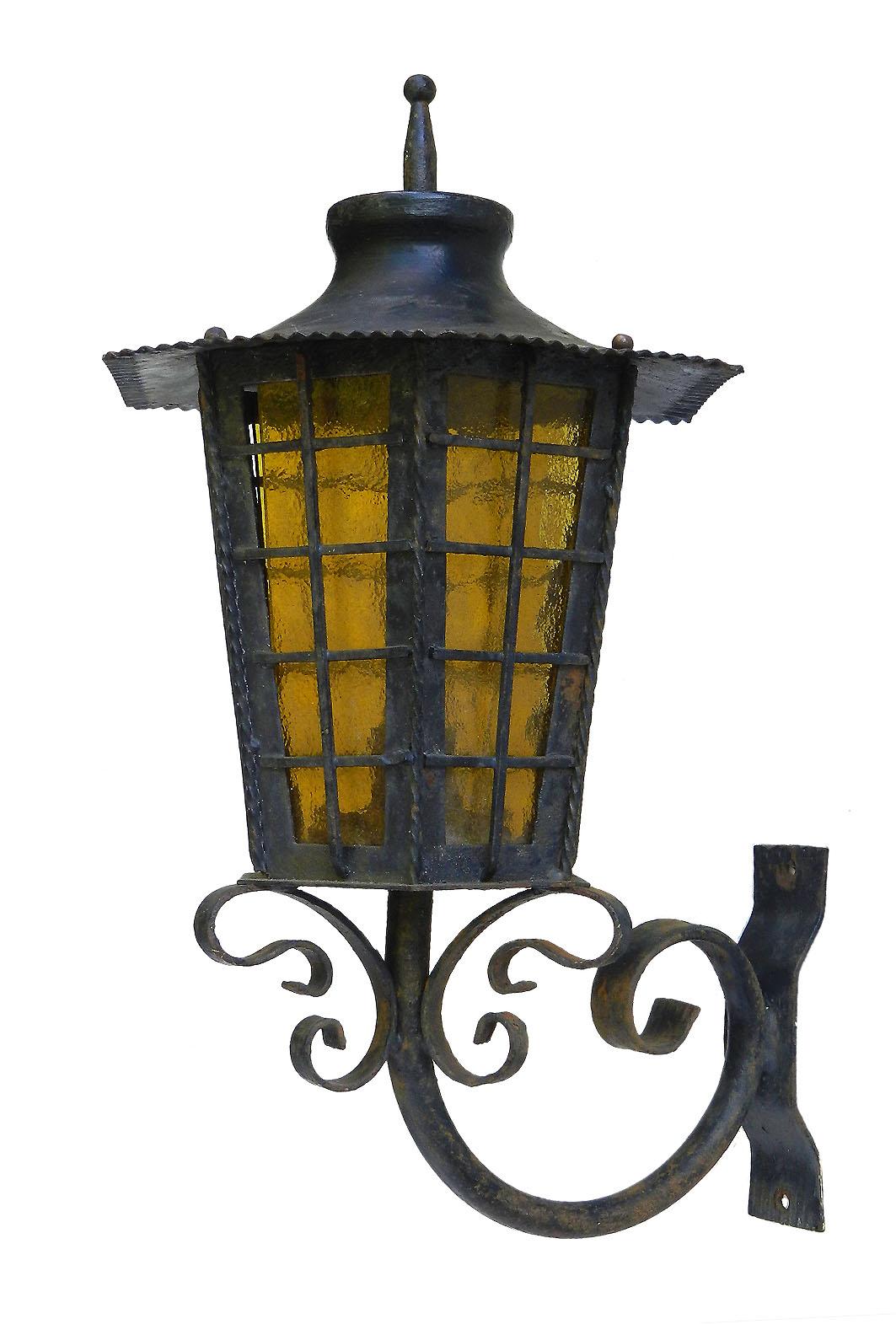 Pair of exterior wall lights lantern sconces wrought iron and obscured amber glass, circa 1920
Great weathered patina, can be re painted if preferred
Good vintage condition sound and solid
These can be rewired to USA and EU or UK