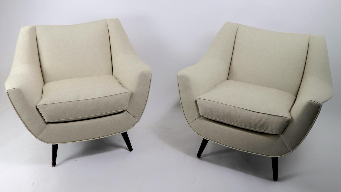 Important pair of club, lounge chairs, designed by Lawrence Peabody for Selig. Large scale, with sinuous and sexy curves make these chairs a statement of chic sophistication, and they are comfortable as well. Newly reupholstered with down cushions,