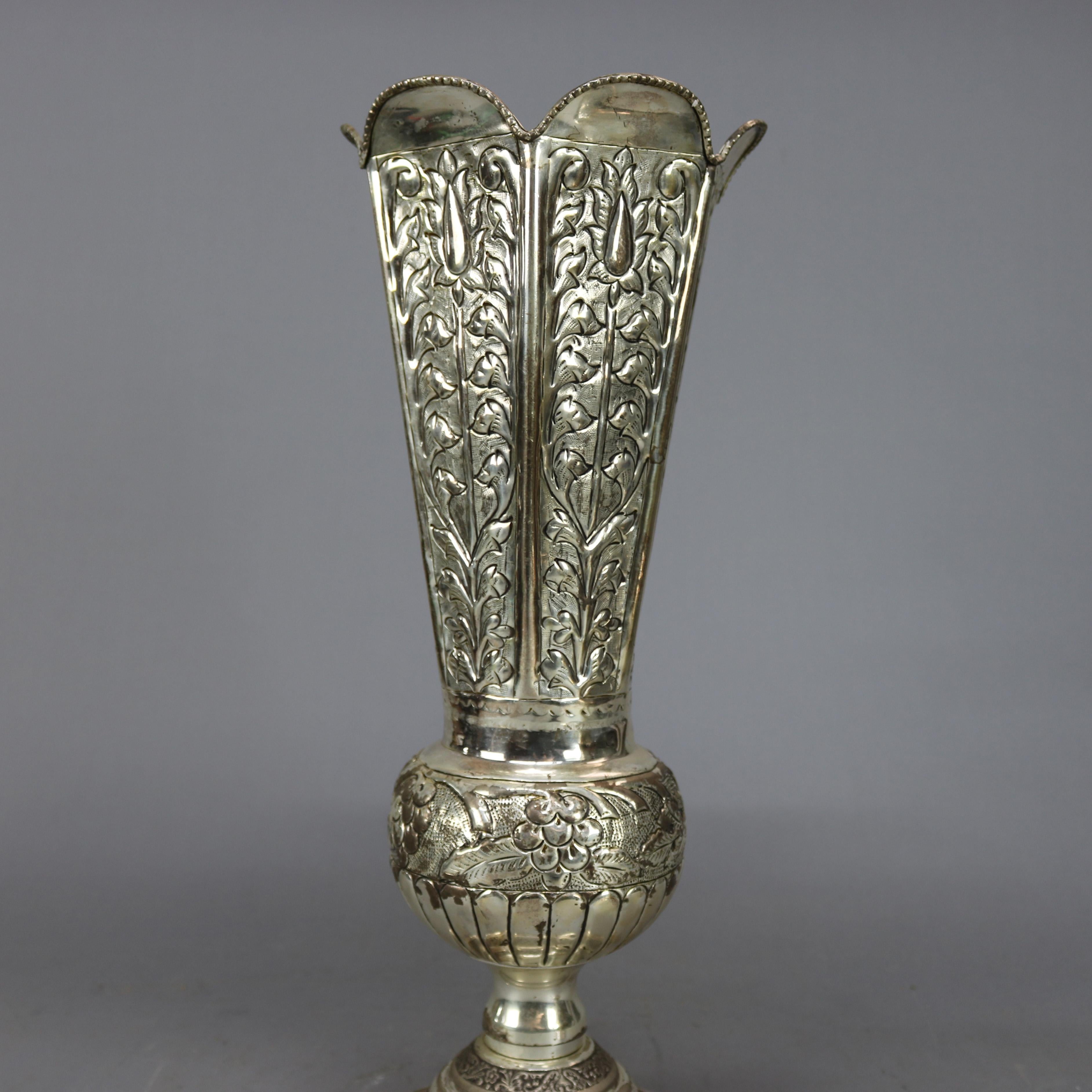 A pair of oversized vintage silver plate vases offer flared and faceted form with scalloped rims, floral repousse embossed relief sides over ball surmounting footed bases, reminiscent of repousse, 20th century

Measures - 20.5