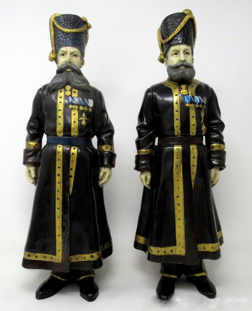 A pair of bronze figures, inscribed Fabergé, dated 1912
This rare pair are in cold painted bronze and are of A.A. Kudinov and N.N. Pustynnikov, personal Kamer-Kazak bodyguards of Dowager Empress Maria Feodorovna and Empress Alexandra Feodorovna, in