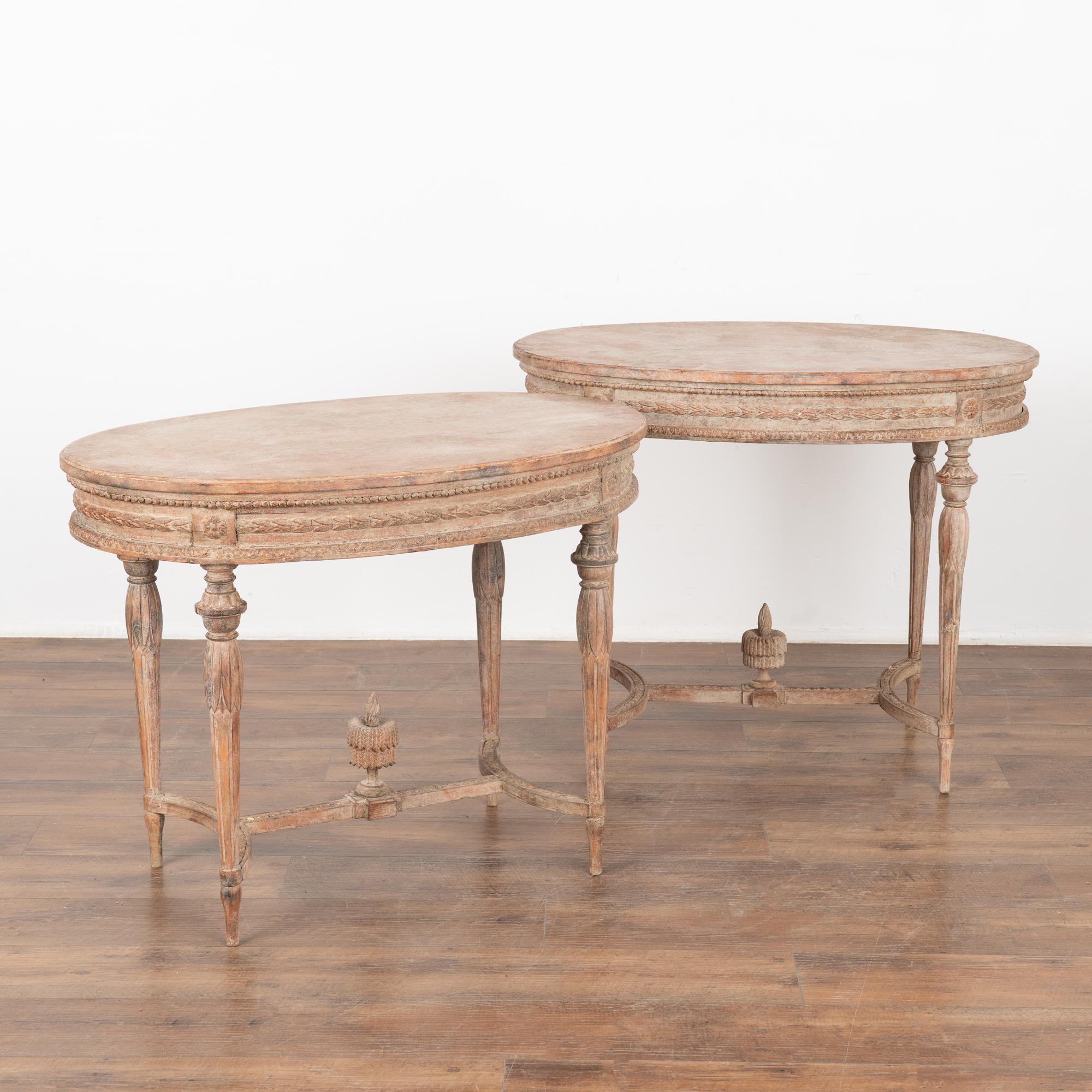 Pair of lovely oval side tables with turned legs, highly decorative carved skirt and finials above stretcher base.
Restored, later professionally painted in muted shades of rose, soft white and blush, all lightly distressed to fit the age and grace