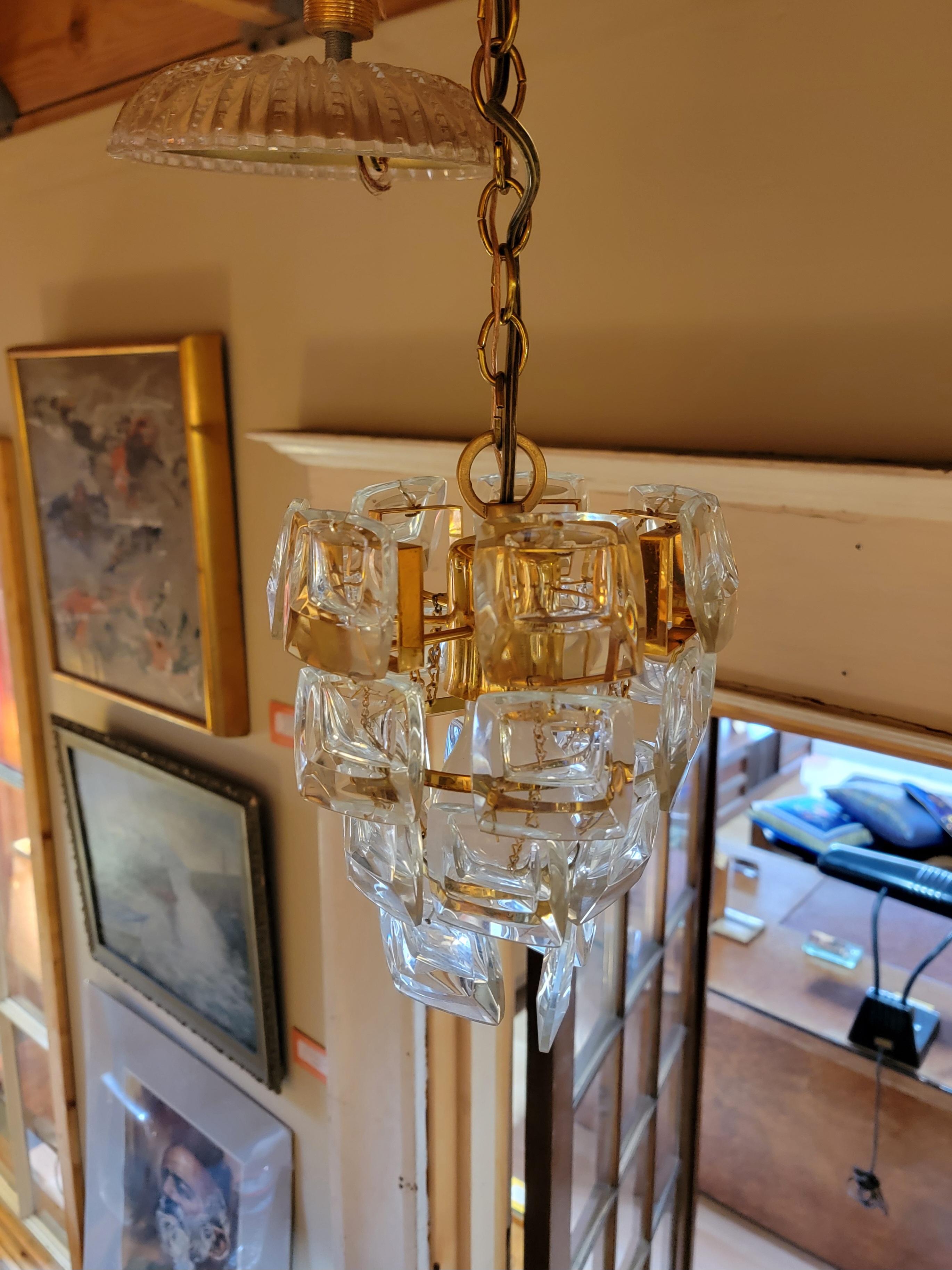 A pair of conical ceiling lights / pendant lights by Palwa, Germany. Attributed to Gaetano Sciolari. Circa. 1970's. Original escutcheon plates made of brass with a glass cover. In original working order. Chain length measures approximately 20