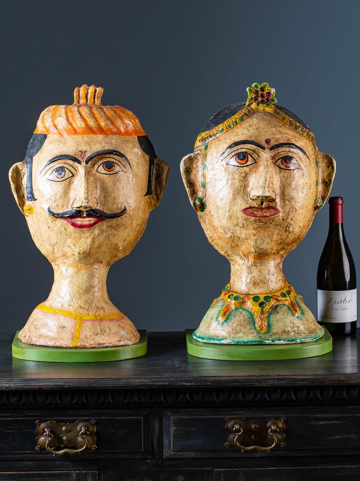 A pair of absolutely charming vintage Indian papier mâché portrait busts of a male and female circa 1960 now mounted on custom painted brackets. The three dimensional sculpted quality of these figures gives them a sense of verisimilitude as they may