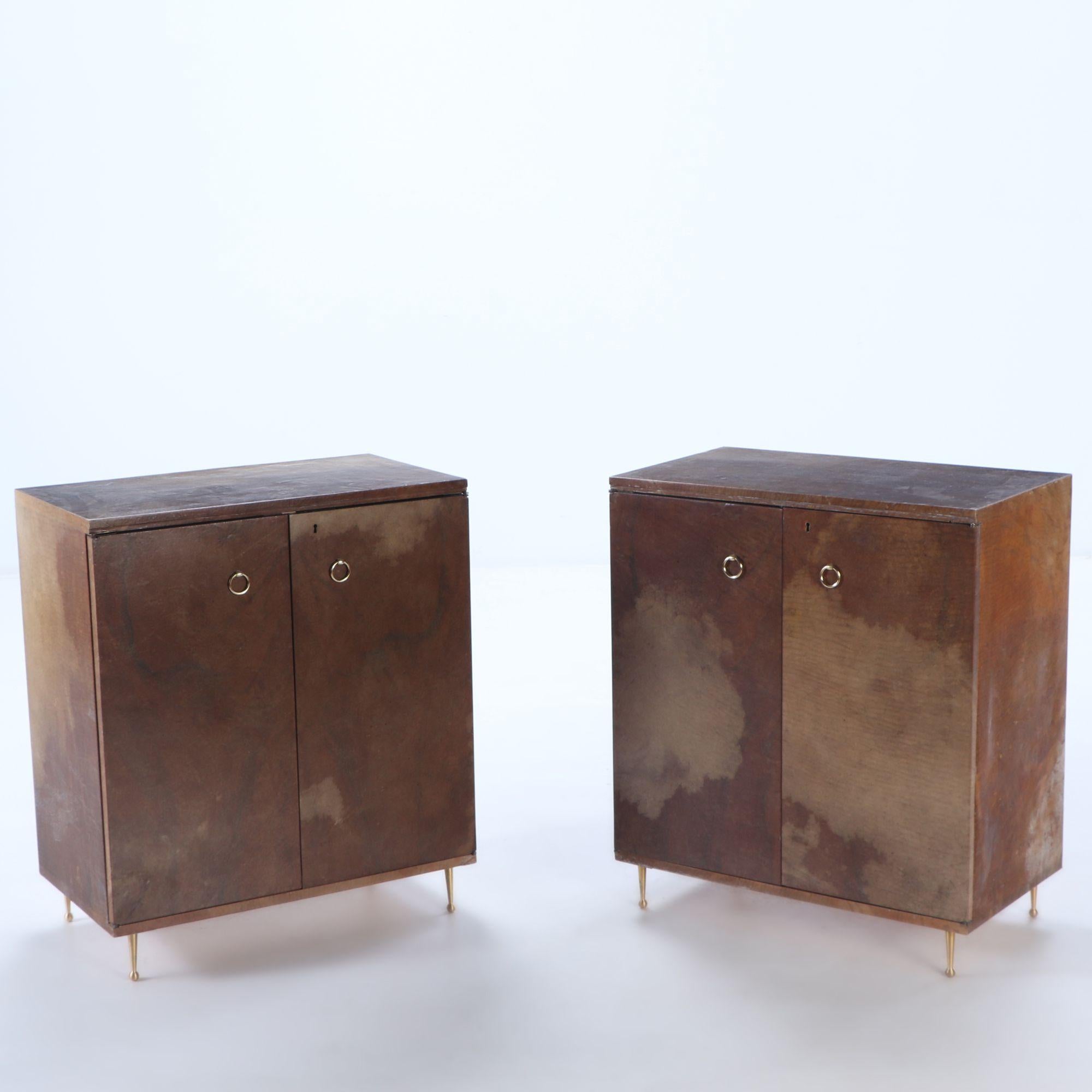 Pair parchment covered two door cabinets C 1950 having adjustable shelves and bronze ring hardware and feet.