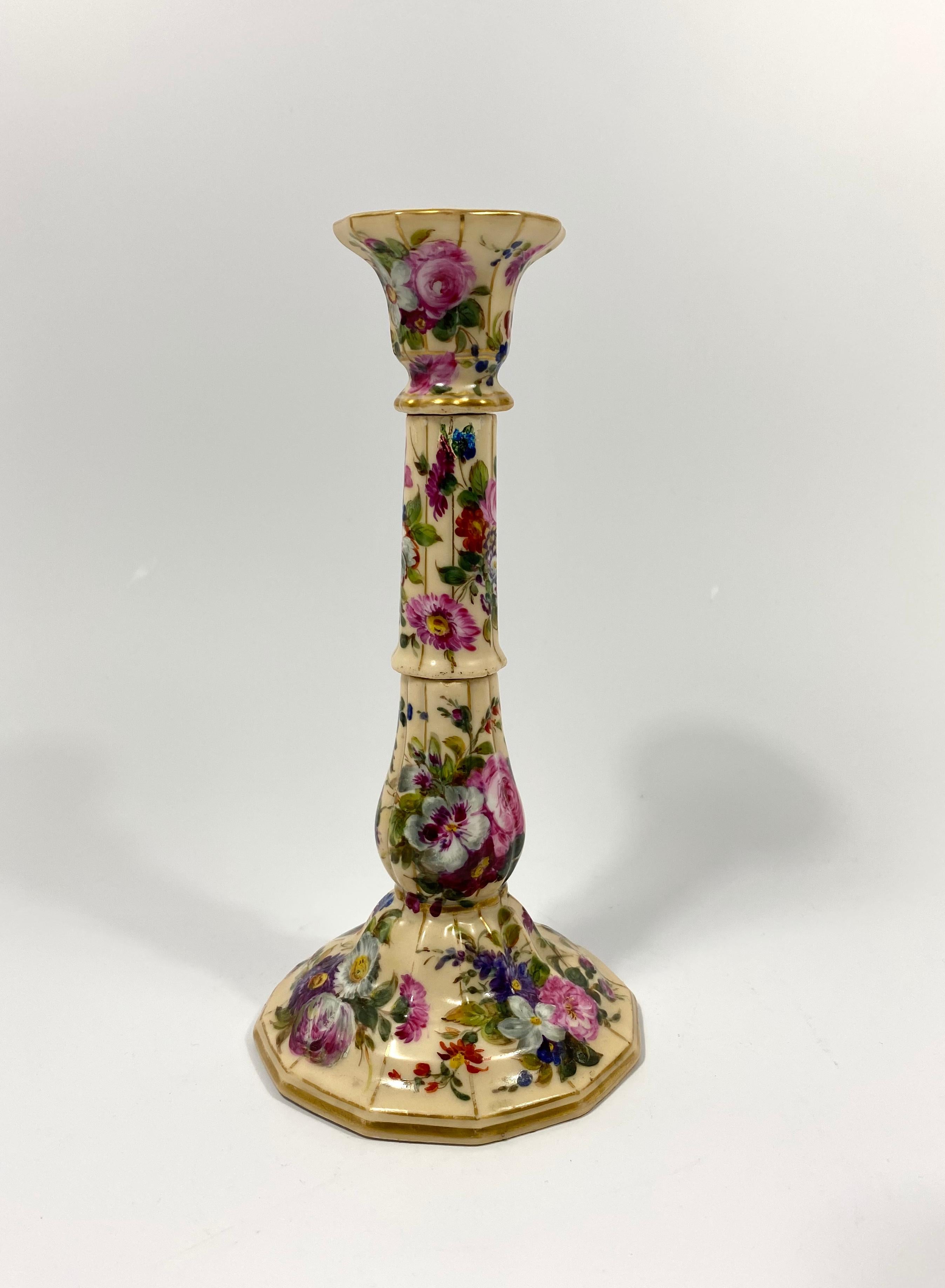 Pair of Paris porcelain candlesticks, probably Jacob petit, circa 1840. The elegant, fluted candlesticks, formed as separate porcelain sections, bolted together. Beautifully hand painted with a profusion of Spring flowers, between gilt borders, upon