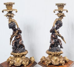Pair Patinated and Gilt Bronze Putti Candlesticks