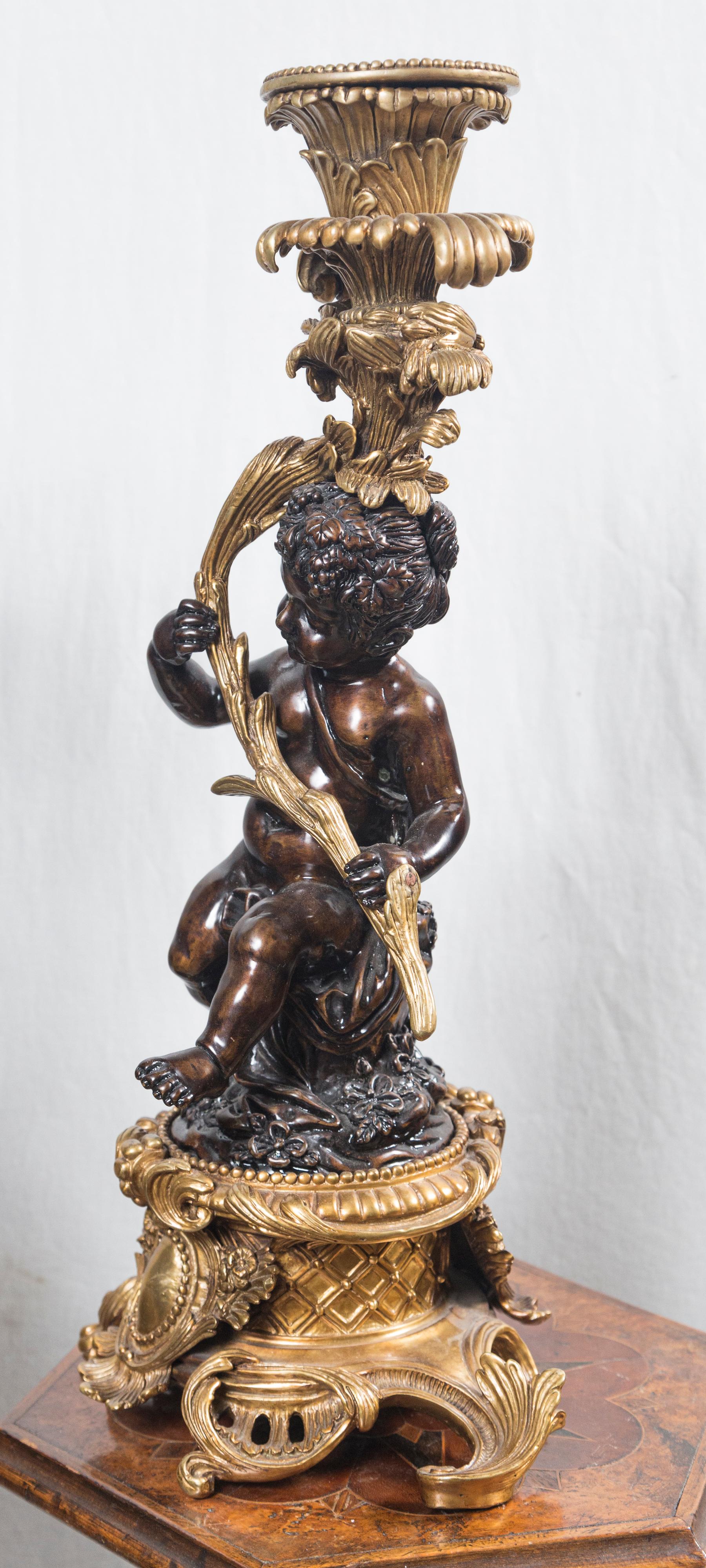 Pair Patinated and Gilt Bronze Putti Candlesticks In Good Condition For Sale In Woodbury, CT