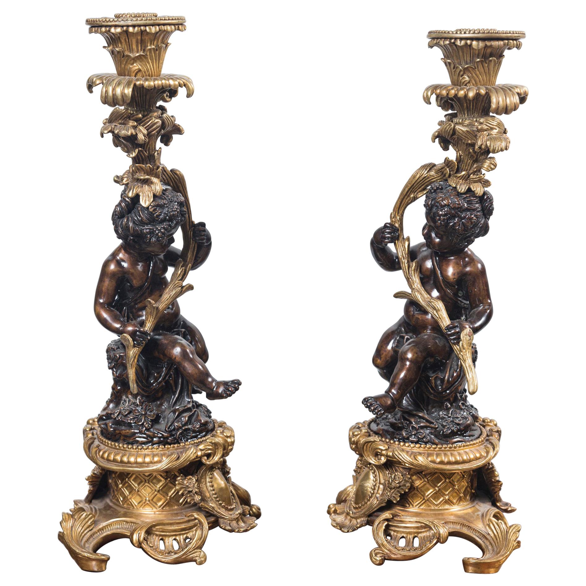 Pair Patinated and Gilt Bronze Putti Candlesticks For Sale