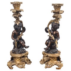 Pair Patinated and Gilt Bronze Putti Candlesticks