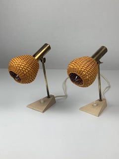 Pair patinated brass and rattan bedside lamps, travertine base, 1960s