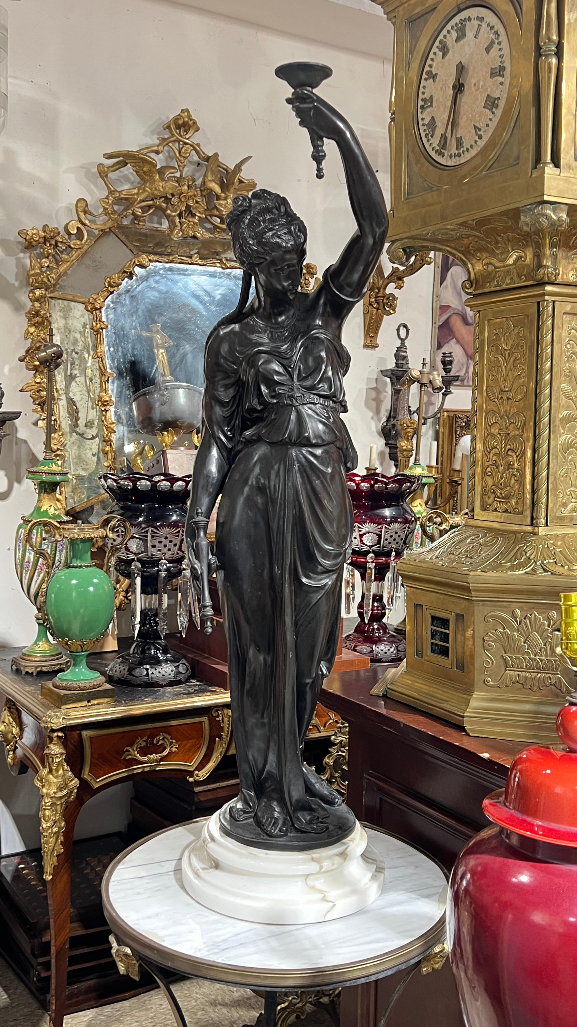 Pair of French mid century Patinated neoclassical bronze female figures designed as torchieres.  Sockets, wiring and glass shades may be added upon request.