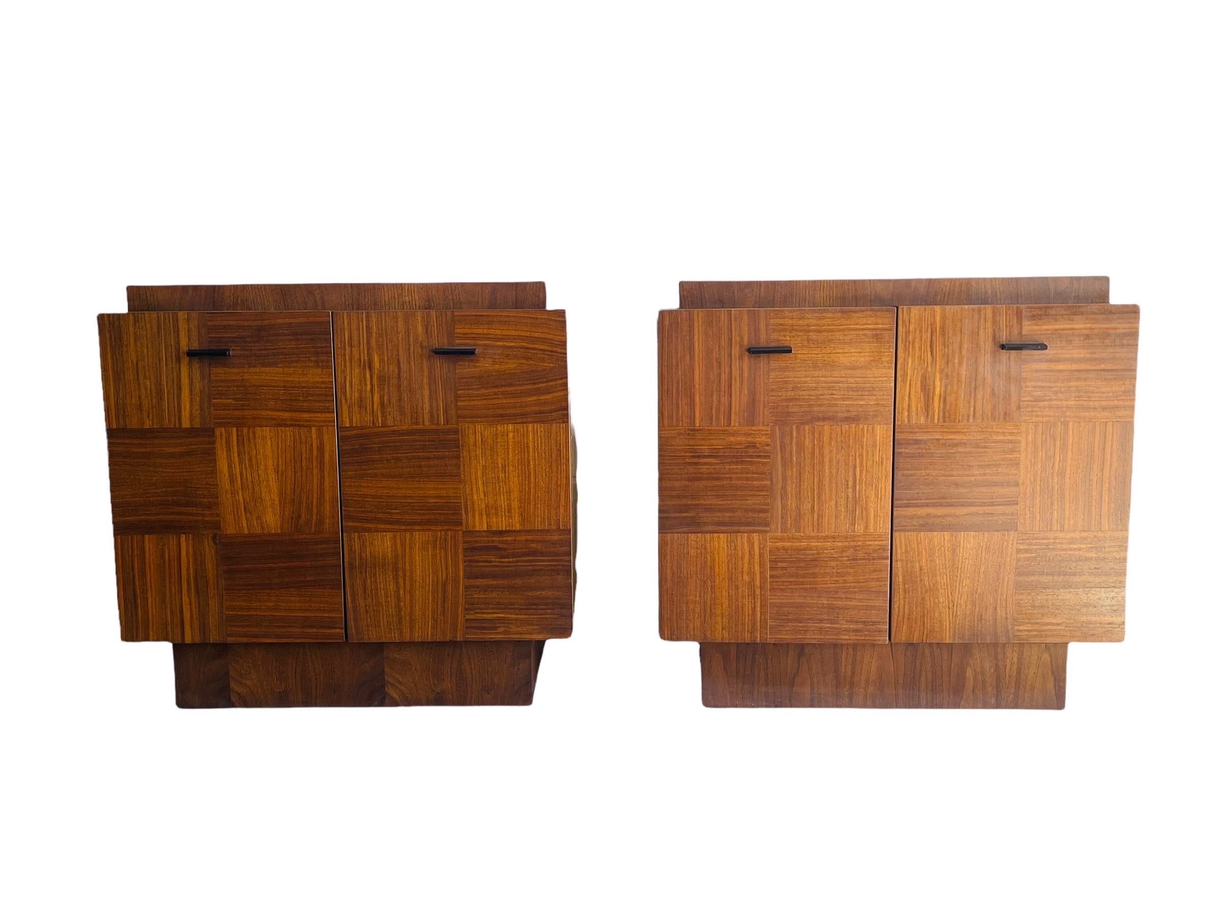 Pair of Mid-Century Modern walnut nightstands in style of Paul Evans by Tobago Furniture company. These nightstands are in good vintage condition with normal wear consistent with age and use. 

Measures: W 26” x D 17.25” x H 25”.