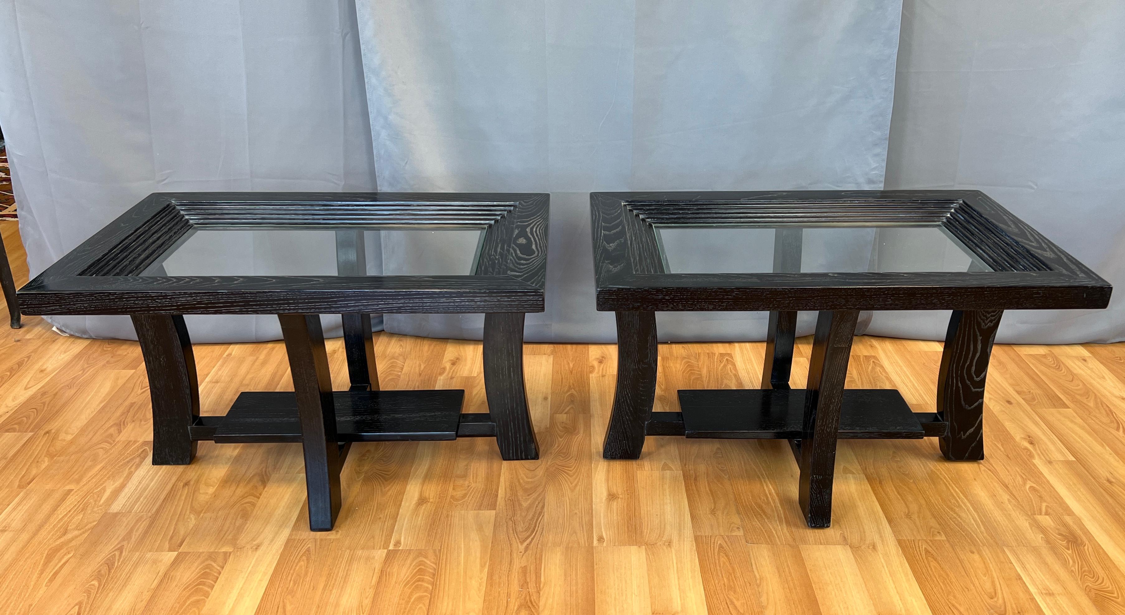 Offered here is a pair Paul Frankl designed side tables for Brown Saltman.
Ebonized oak, with glass, table tops have a step down design, with a small shelf below.