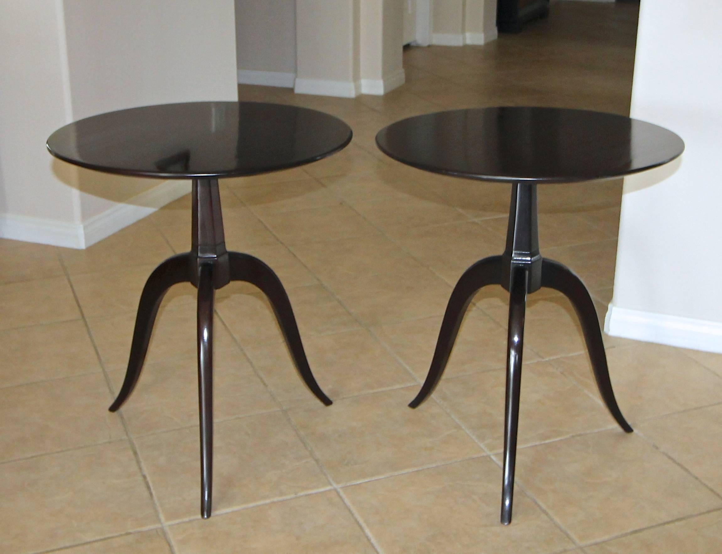 Pair of round top dark walnut/espresso finish wood side or end tables by Paul Frank for Brown Saltman. Solid wood construction tables resting on gently curved tripod legs. More recently restored.
