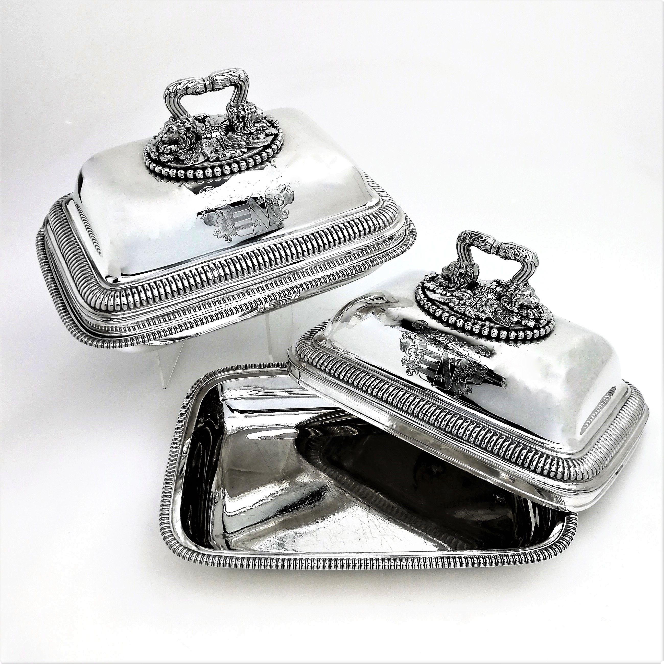 A magnificent pair of Paul Storr Antique Solid Silver Entree Dishes. These impressive Antique George III Covered Dishes are rectangular in shape and have tall domed lids topped with monumental handles. The Handles are acanthus leaf topped ending in