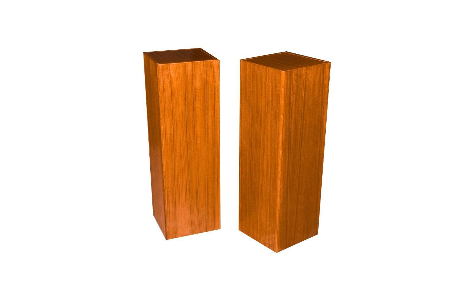 A handsome, sleek Danish Modern pair of pedestal/plant stands, circa 1970s by FBJ Mobler made in Denmark. Each features a square top showcasing the teak grain. Finely constructed with rounded edges, above a sturdy frame, with simplicity and