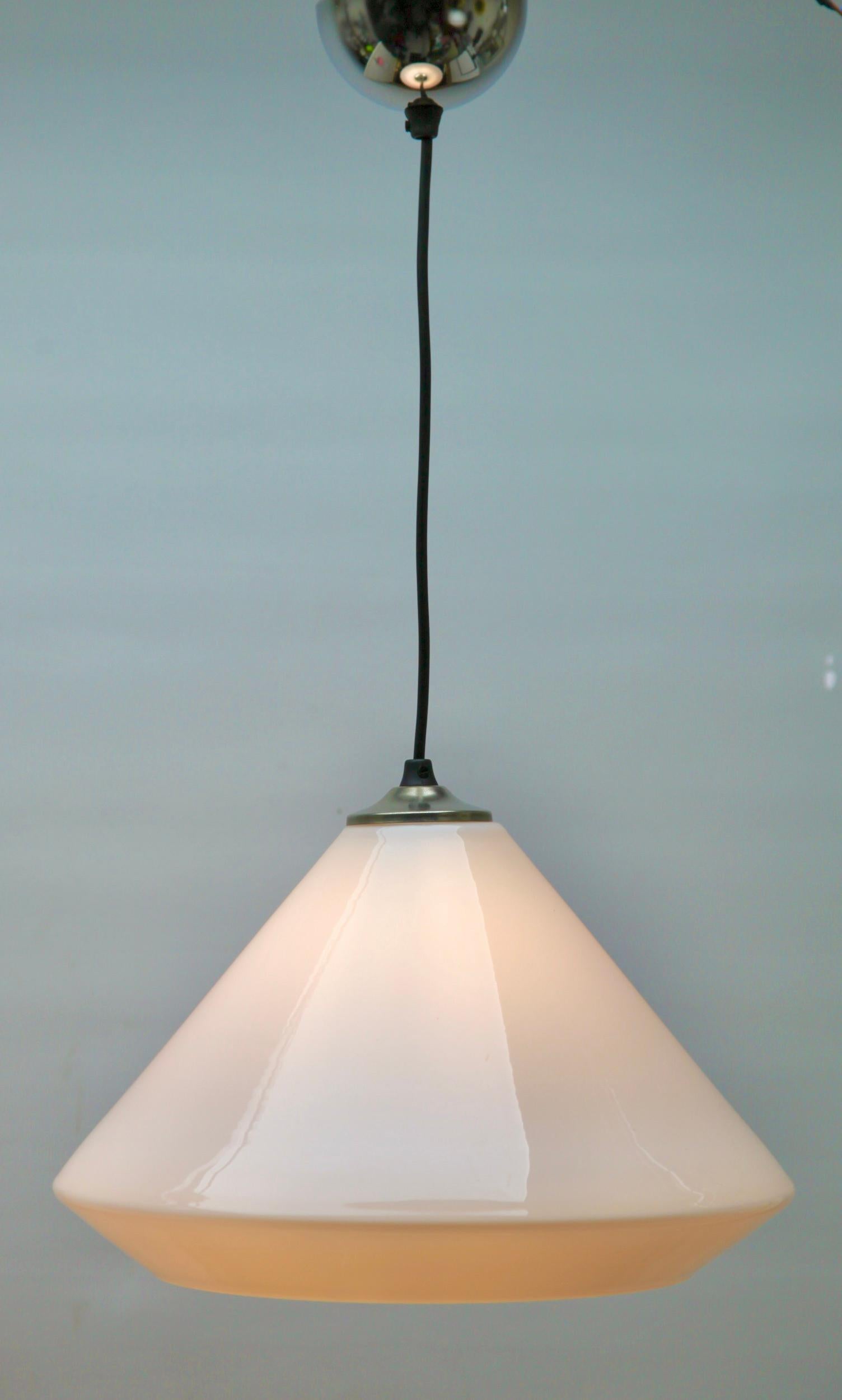 From the range by the Phillips Company, this center-light on a central chain. The lamp has a fitting on a chromed plate and holds a stepped globular shade of opaline glass.

In good condition and in full working order with standard new lamp