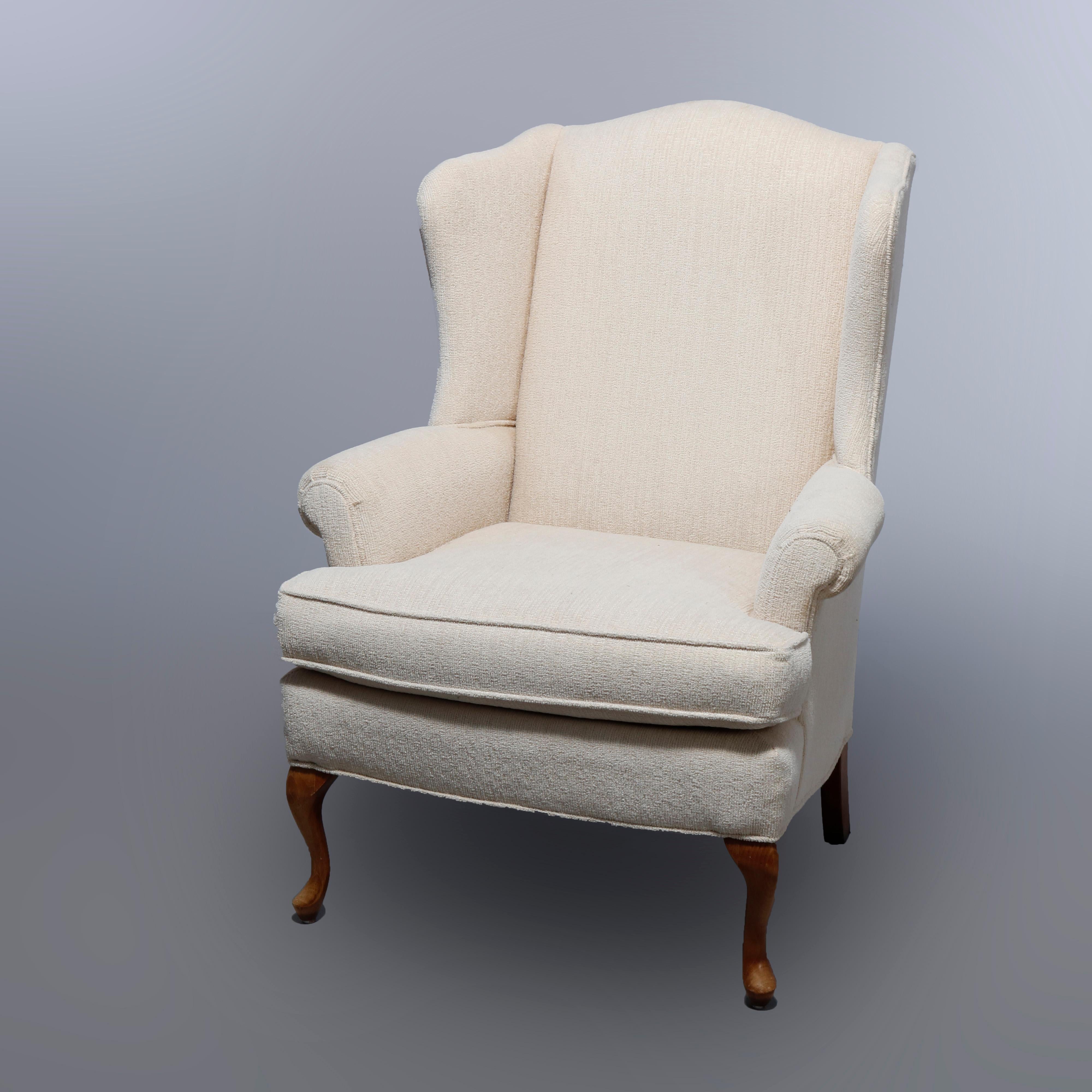 A pair of Queen Anne style fireside wingback chairs by Pennsylvania House offer shaped back and scroll arms raised on mahogany cabriole legs, label as photographed, 20th century

Measures: 42.25
