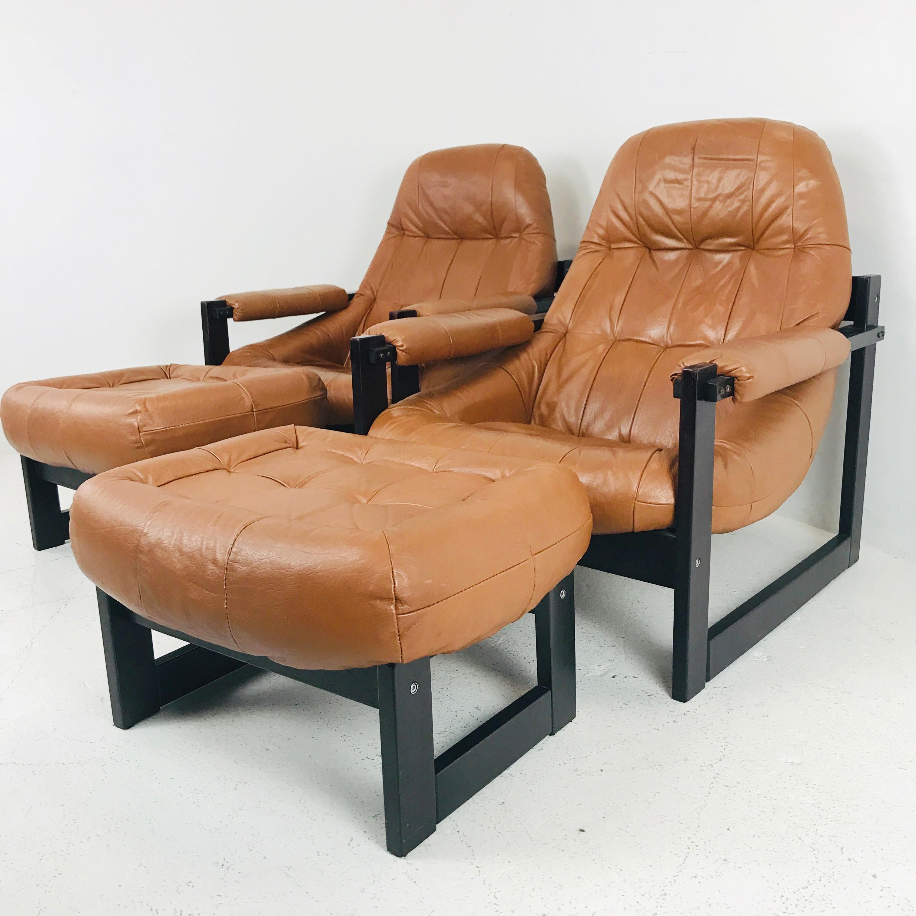 Pair of Percival Lafer leather and wood lounge chairs and ottomans. Chairs are in good vintage condition with wear consistent with age and use. See photos.

Dimensions:
31 W x 33 D x 34.5 H
Seat height 15.