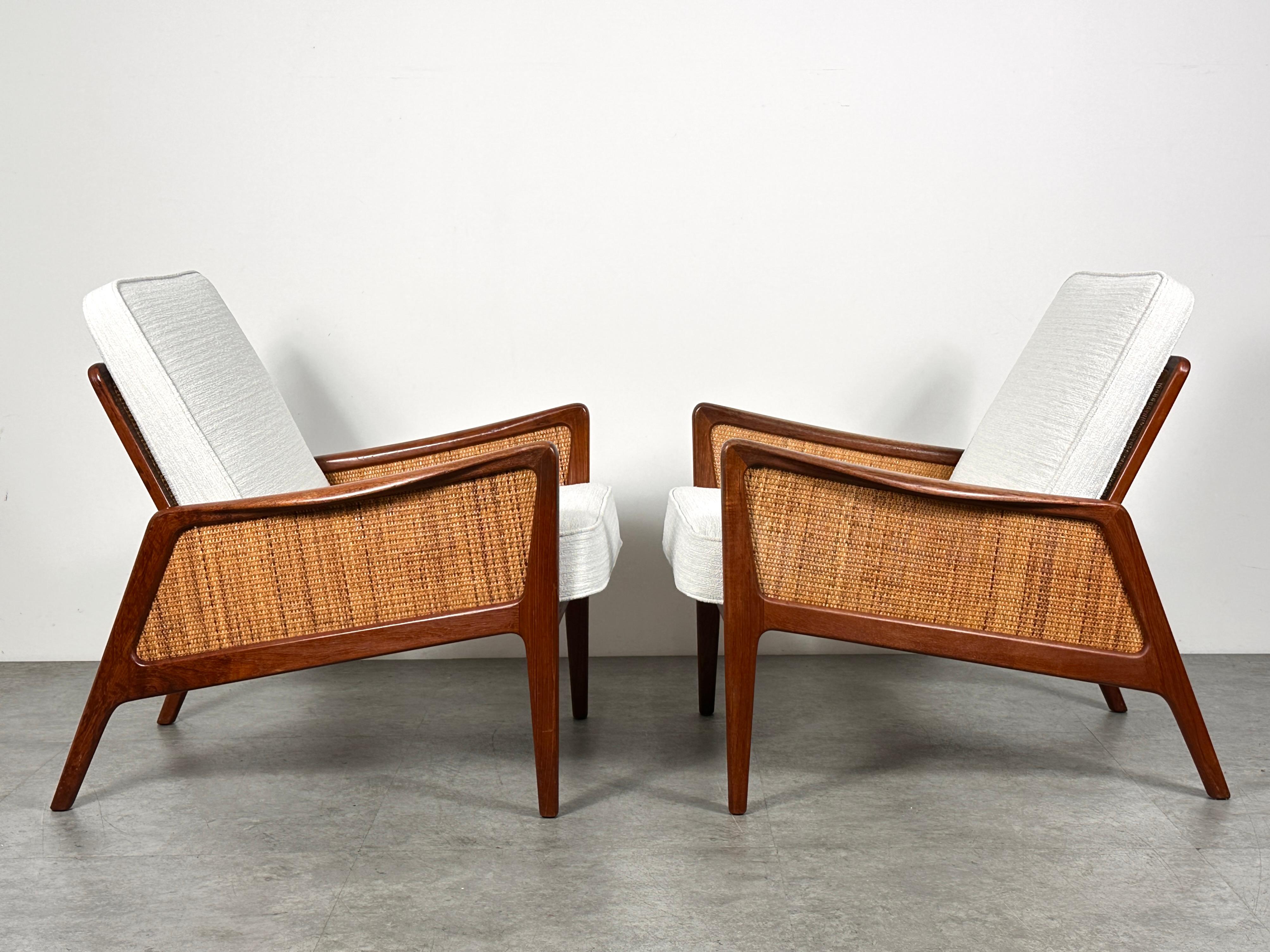 A rare pair of model FD-151 lounge chairs by Peter Hvidt and Orla Molgaard Nielsen
Designed in 1956 for France and Daverkosen
Sculptural solid teak frames with woven cane panel sides and back

Manufacturer markings to frame interior 

26