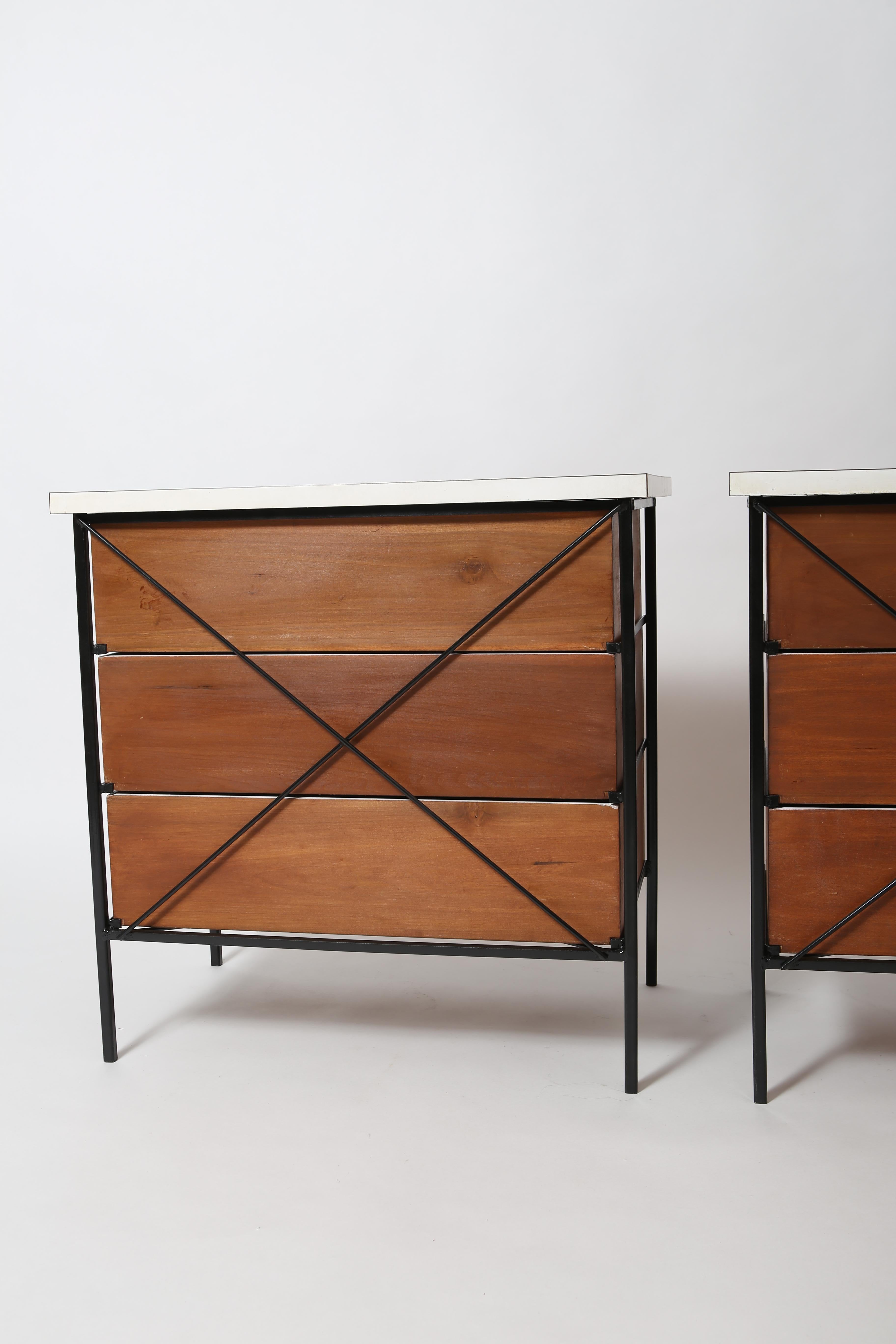 A pair of classic California modernist chests of drawers by Vista of California. Square steel tube frames are stunning from any angle. Original white Formica tops and refinished maple drawers. Chromed steel hardware.